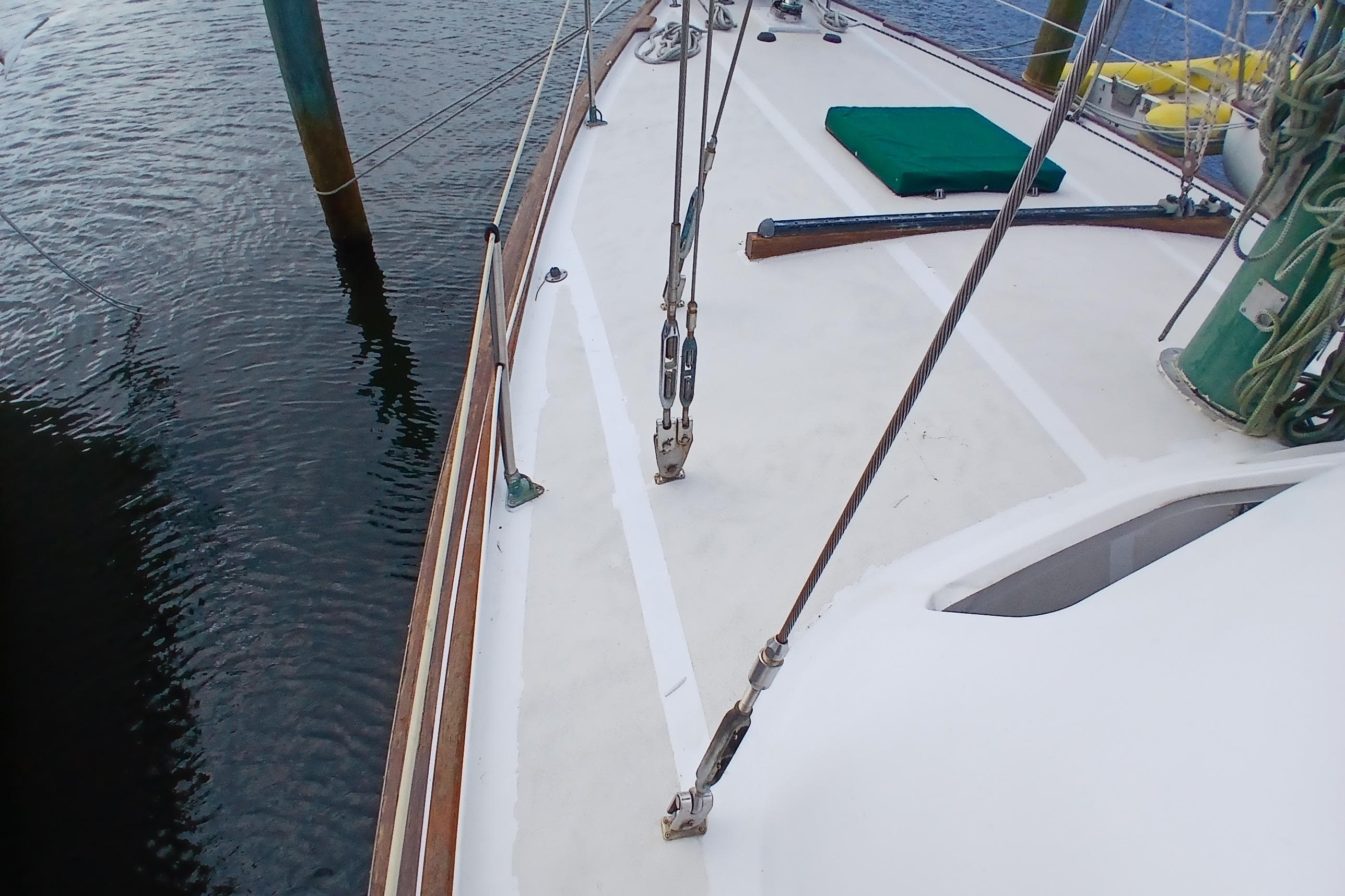 Deck view of 1981 Wellington 44 Center Cockpit sailboat, showing rigging and water.