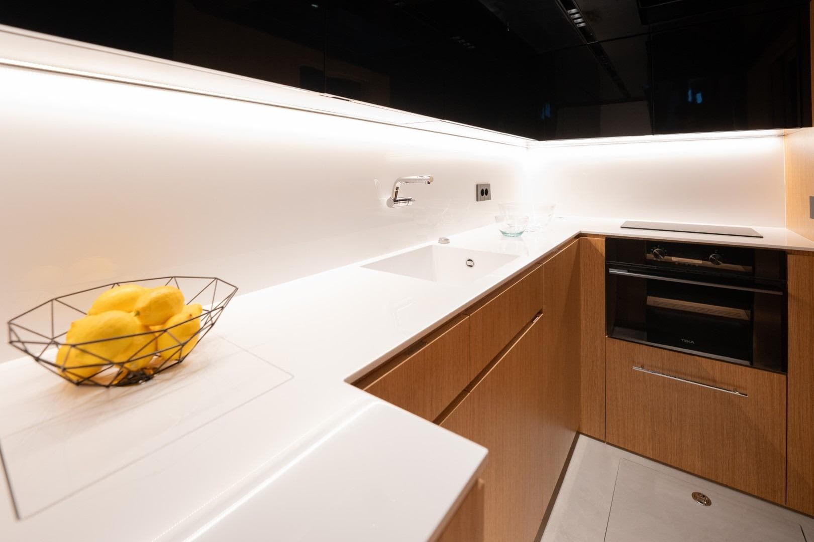 Modern kitchen interior on 2026 De Antonio Yachts D60, featuring sleek design and wooden cabinetry.