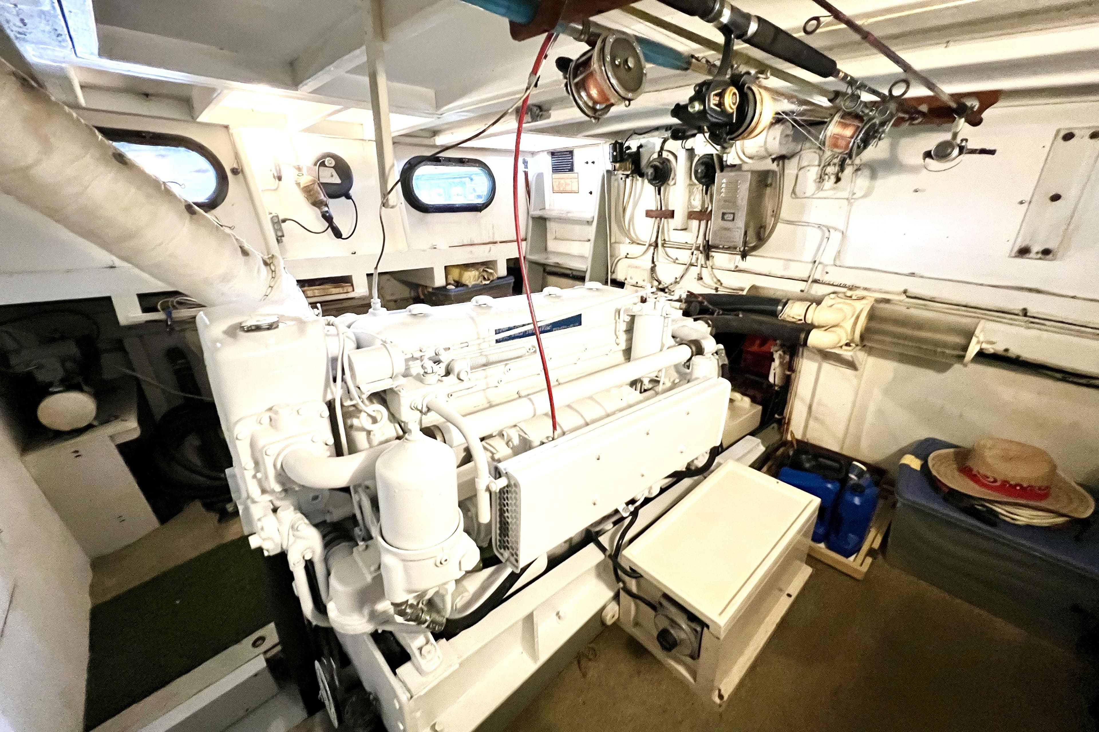 Engine room of a 1972 Mills Boat Works Tug Boat, showcasing machinery and equipment.