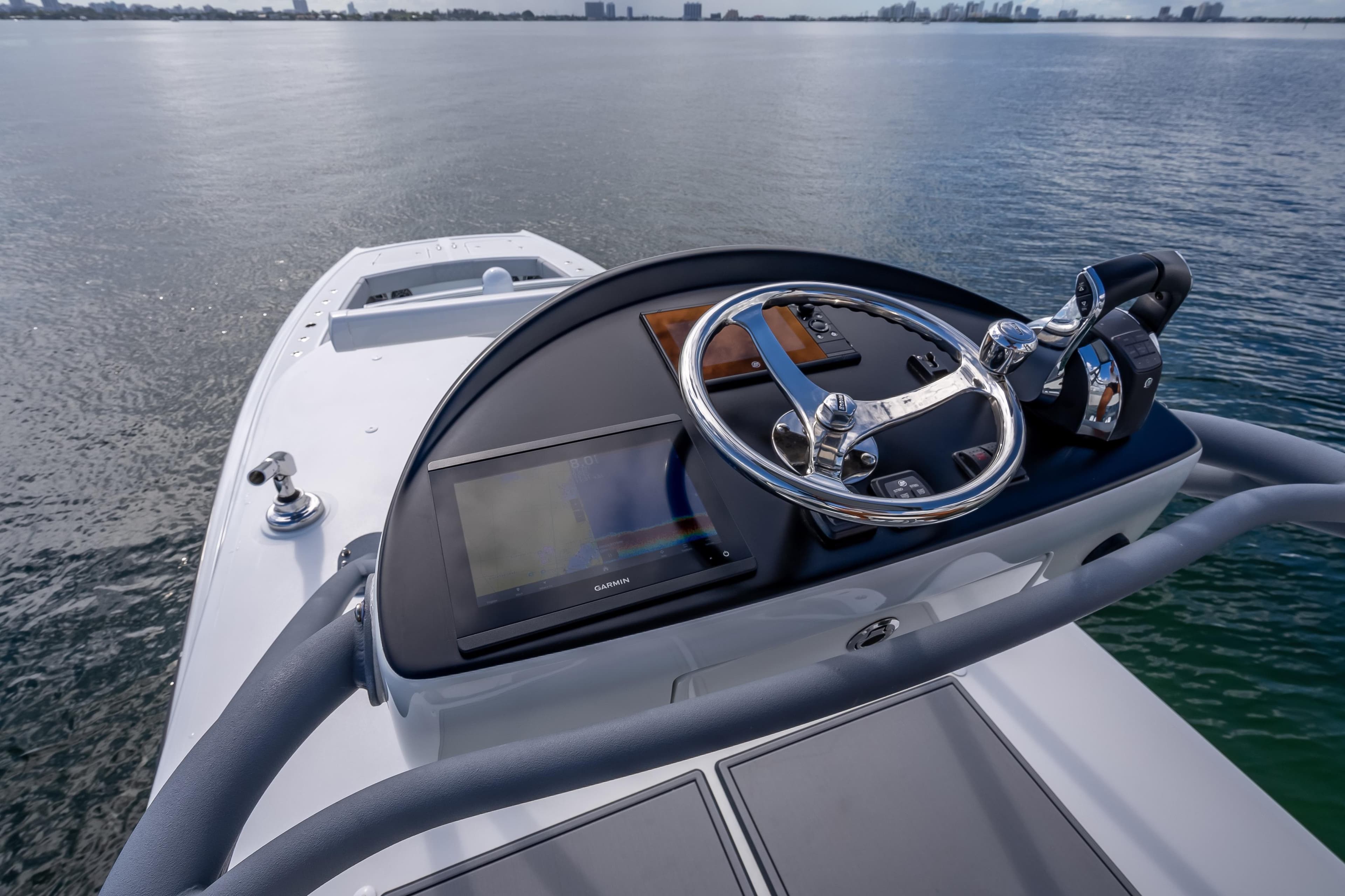 Helm of 2020 Freeman 42LR boat with steering wheel and navigation display.