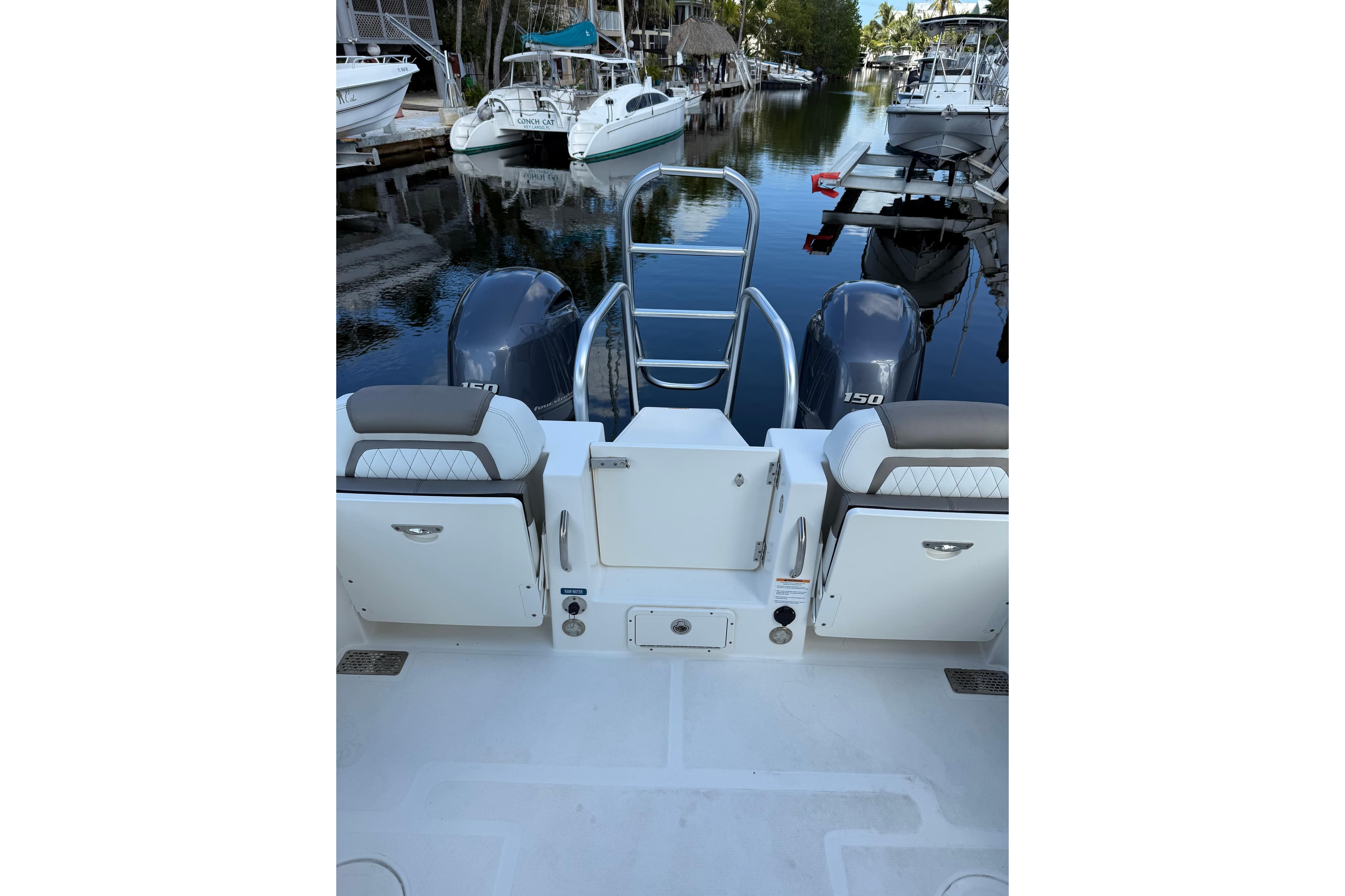 2023 World Cat 255 DC boat with dual engines docked in a marina.