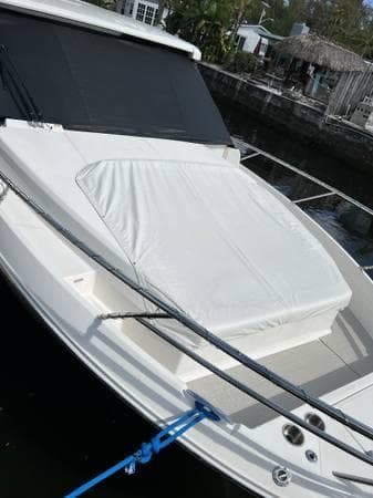 2023 Regal 36 XO boat docked with covered bow area.