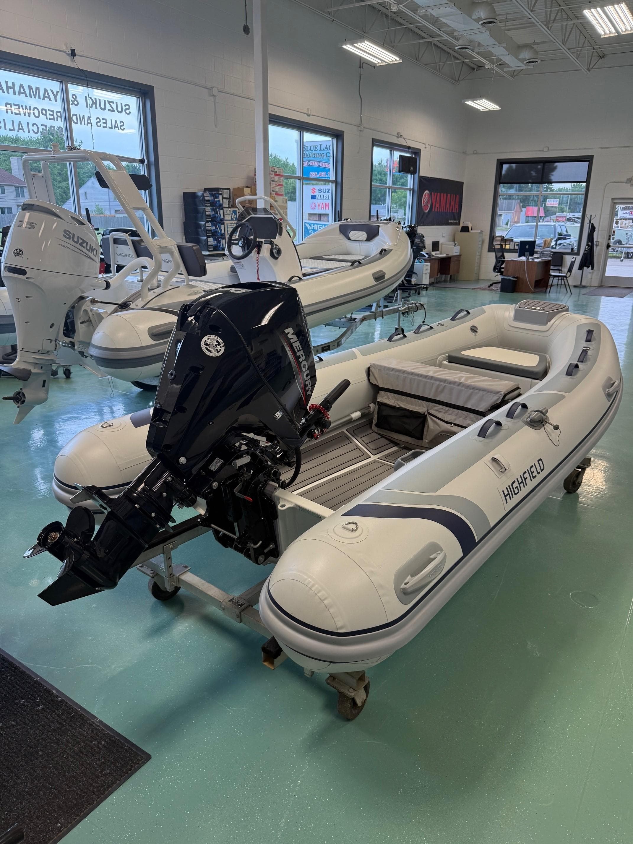 2024 Highfield CL360 inflatable boat with outboard motor in showroom.