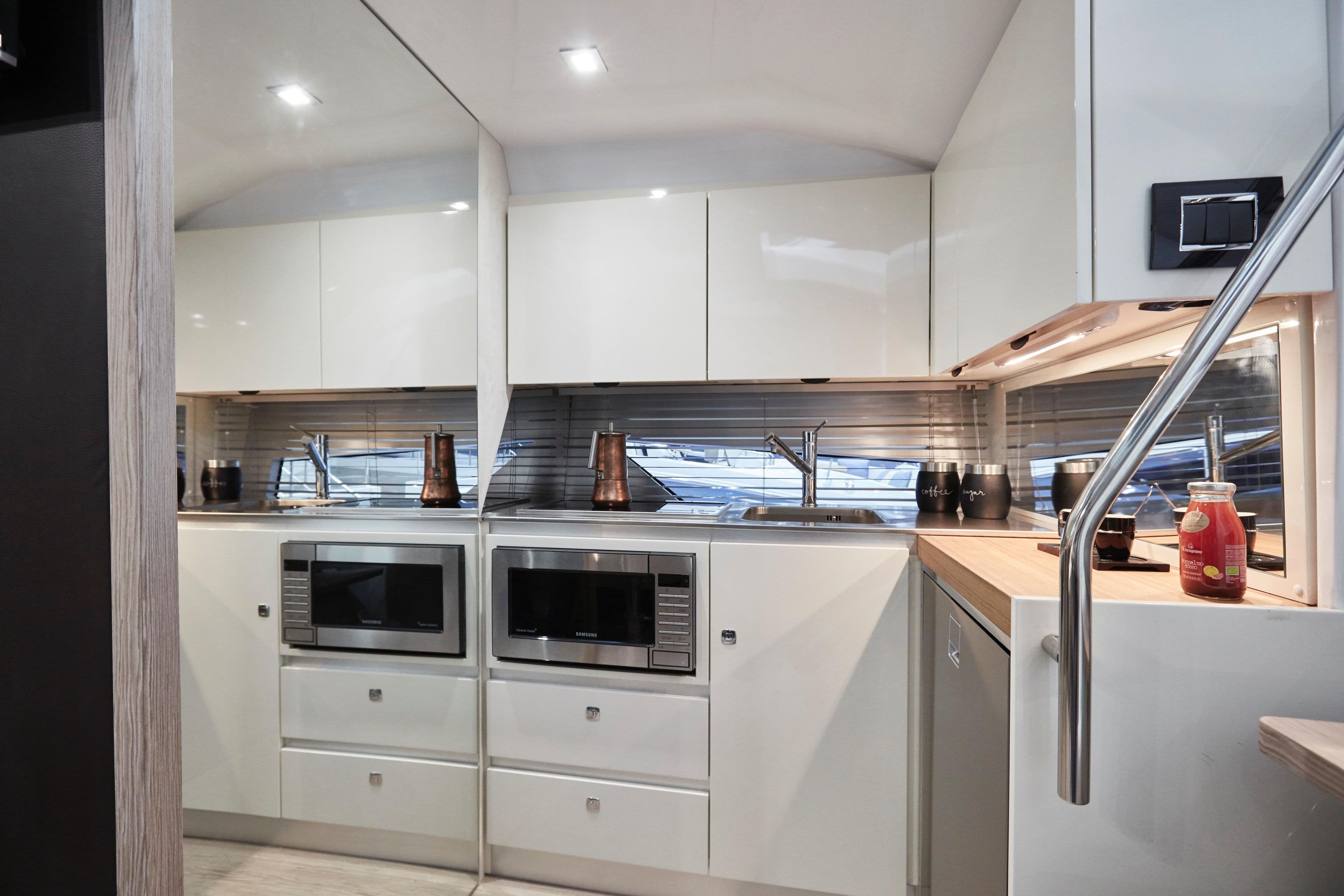 Modern kitchen interior of 2025 Sessa Marine C38 yacht with sleek cabinetry and appliances.