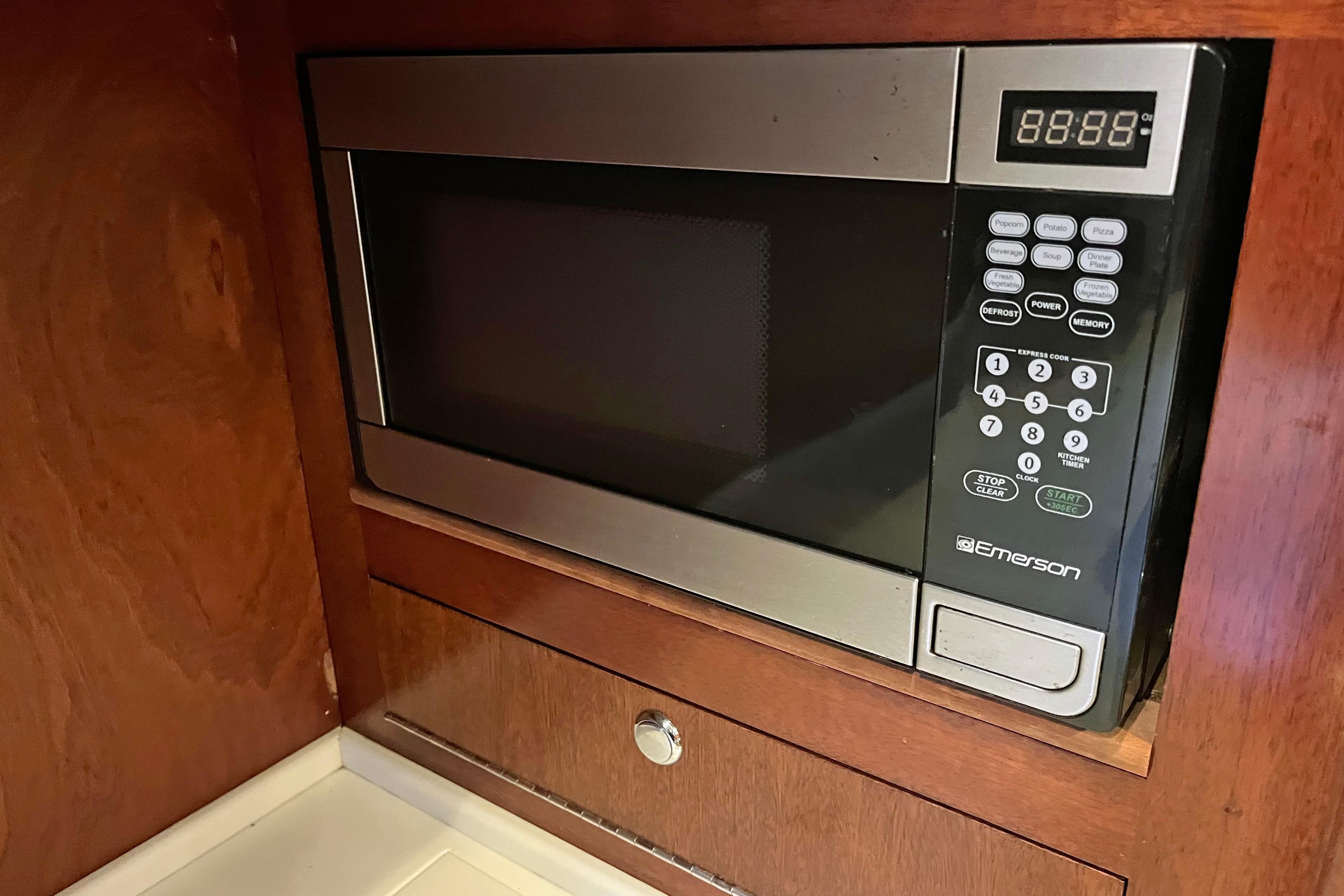 Microwave oven in wooden cabinet on 1979 Amel Mango boat.