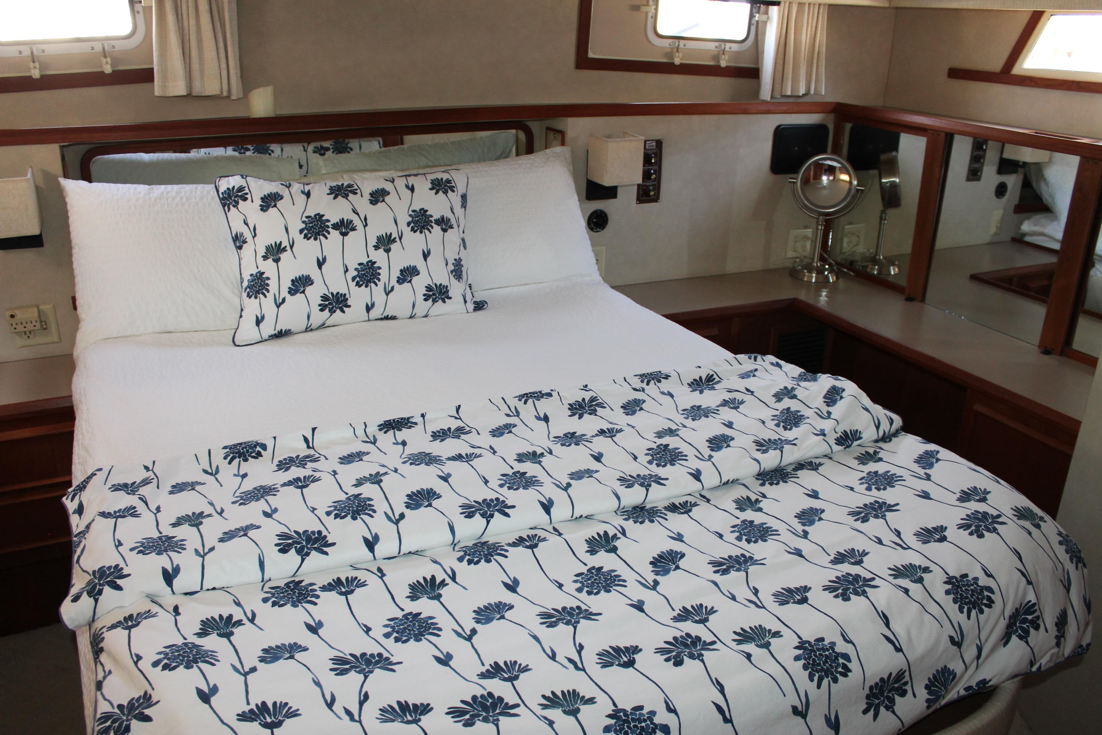 Cozy bedroom in 1987 Chris-Craft 427 Catalina yacht with floral bedding.