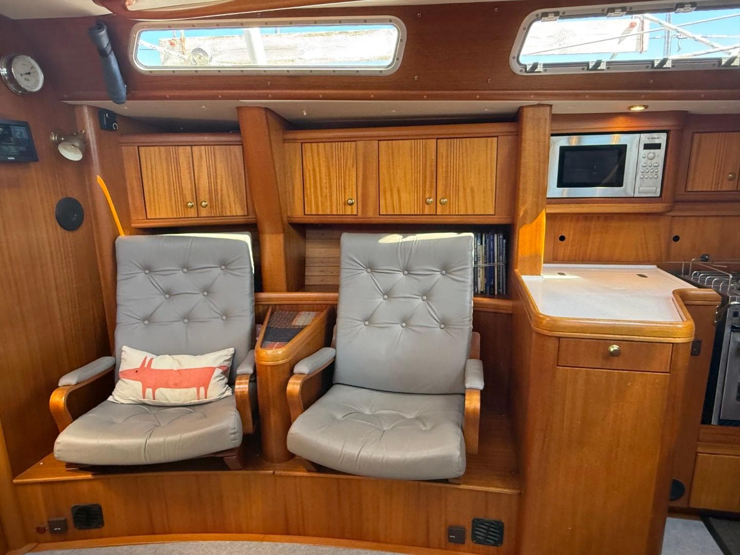 Interior of a 2002 Najad 490 yacht with wooden cabinetry and comfortable seating.