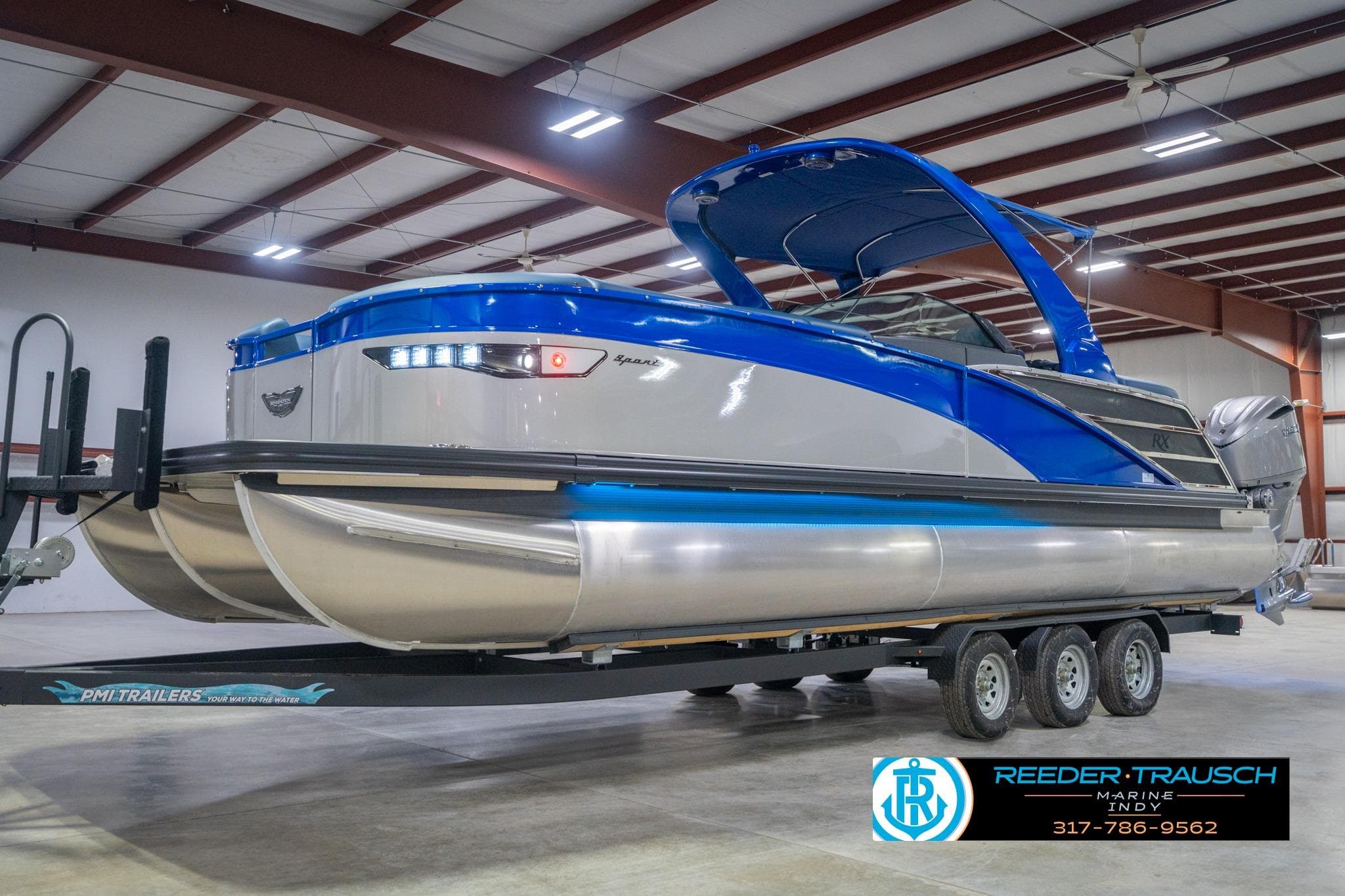 2026 Bennington 27 RX pontoon boat on trailer in indoor showroom.