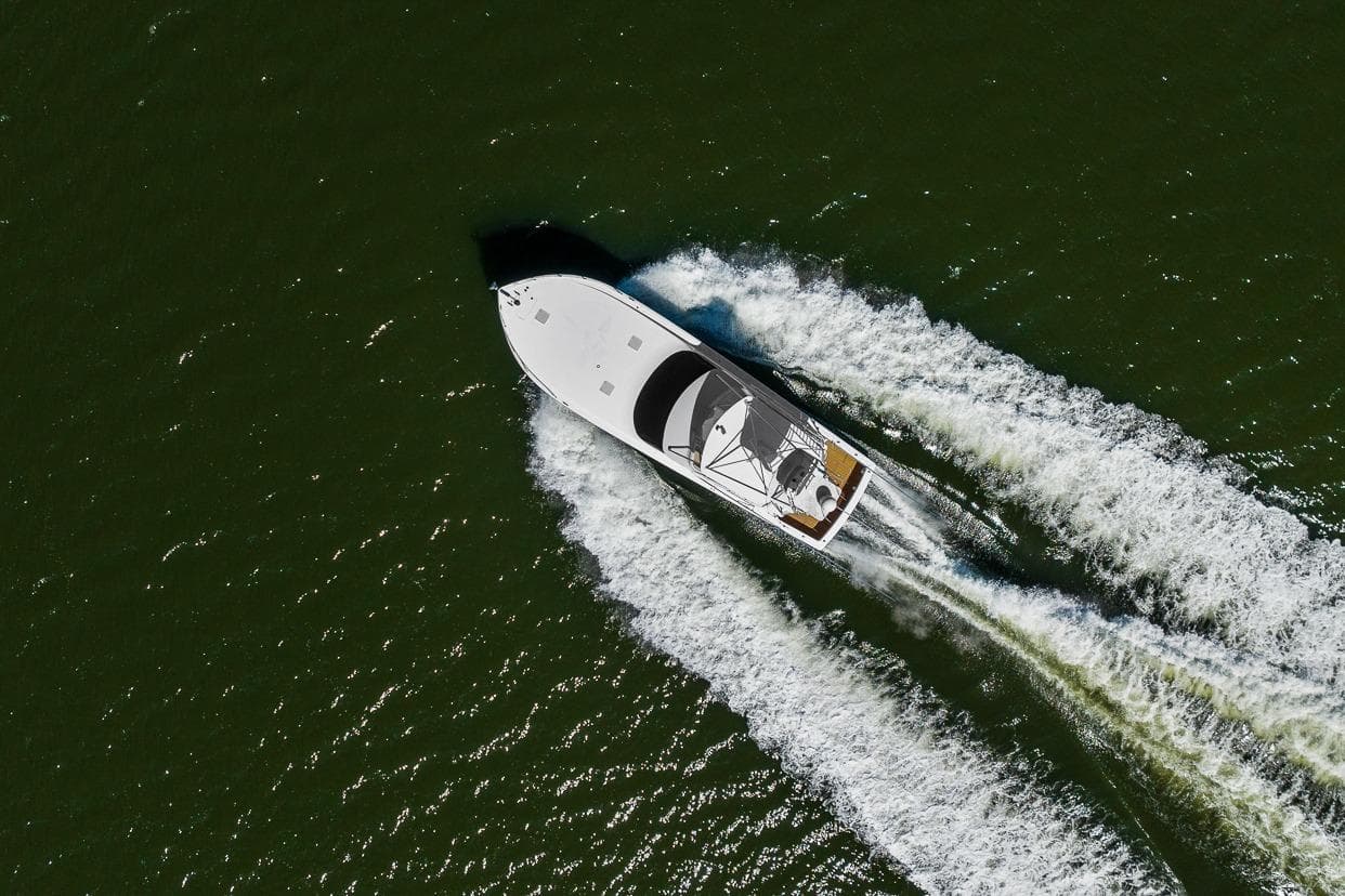 Aerial view of 2002 Viking 61 Convertible yacht cruising on open water.