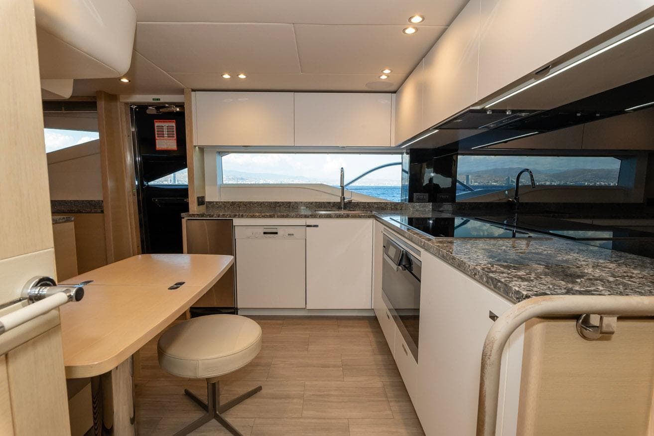 Modern kitchen interior on a 2019 Princess 30M yacht, featuring sleek countertops and ocean view.