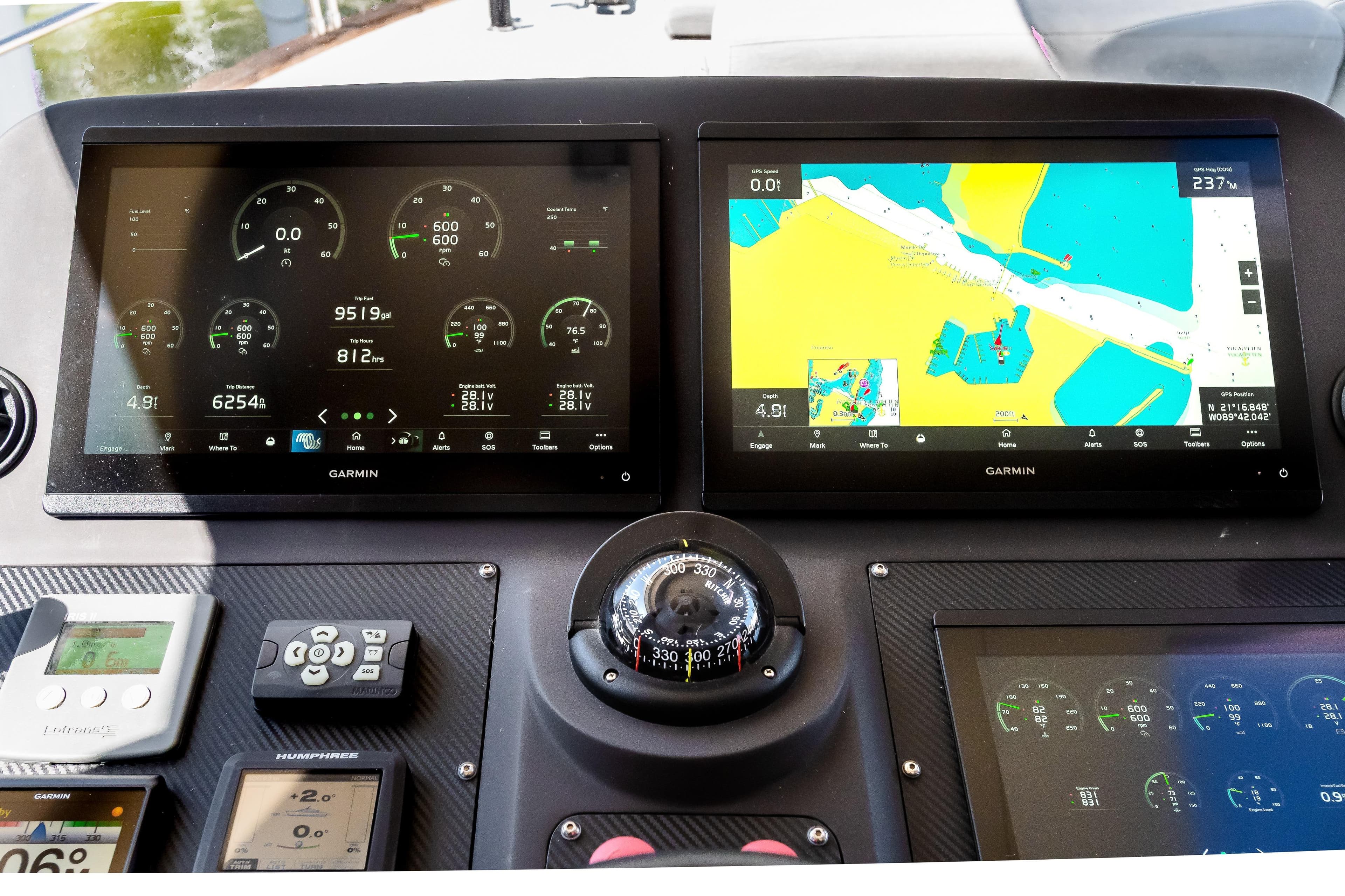 Cockpit of 2023 Sirena 58 yacht featuring advanced Garmin navigation displays.
