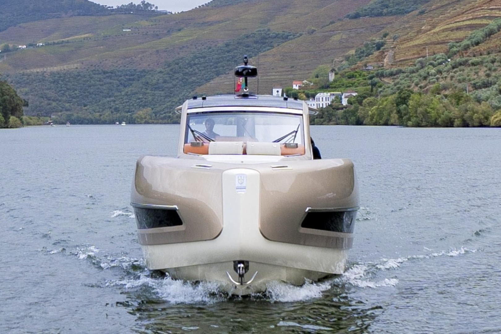 Invictus TT460 2022 luxury yacht cruising on a scenic river.