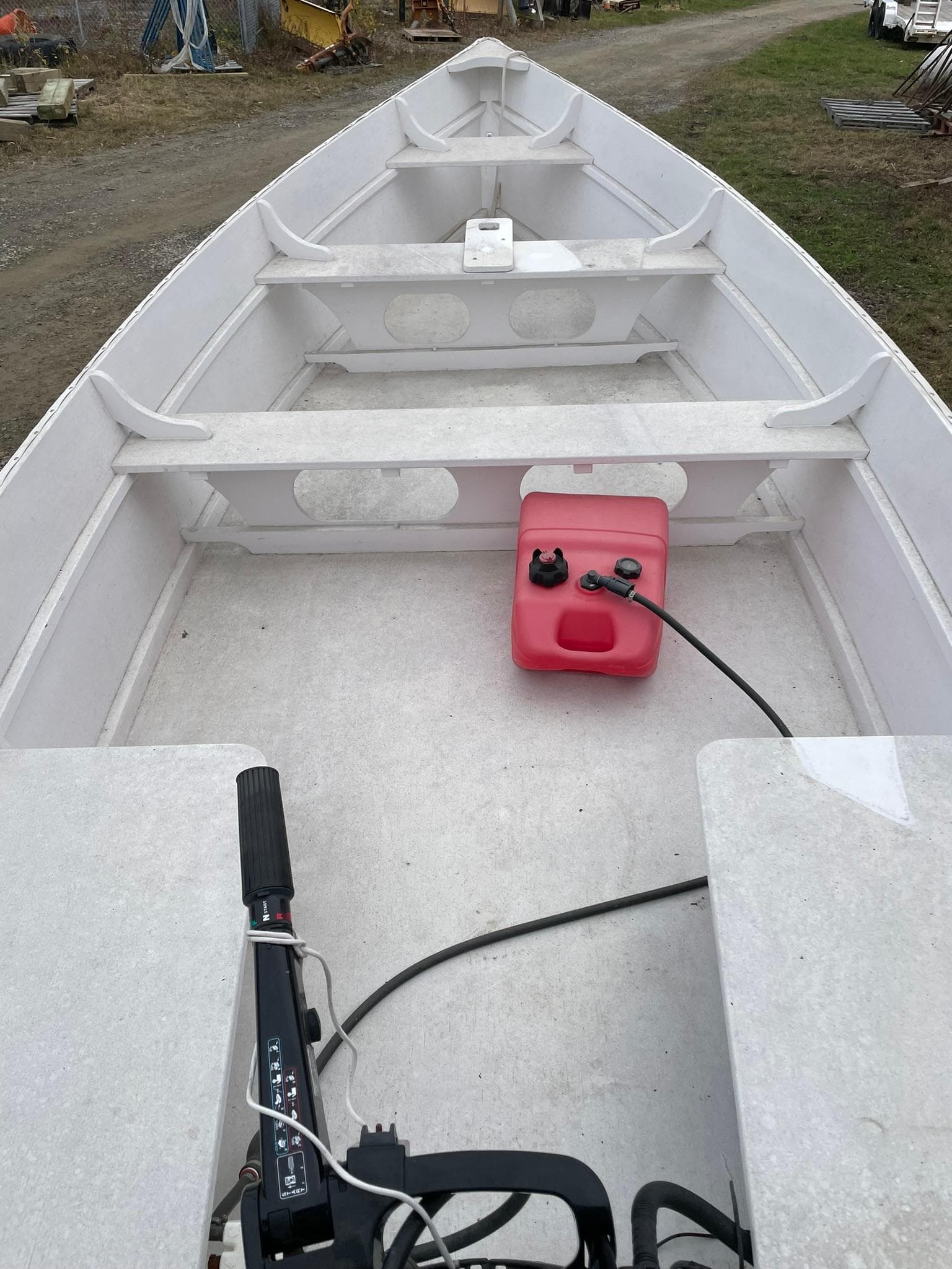 2017 Rossiter Estate Skiff interior with motor and fuel tank on a dirt path.
