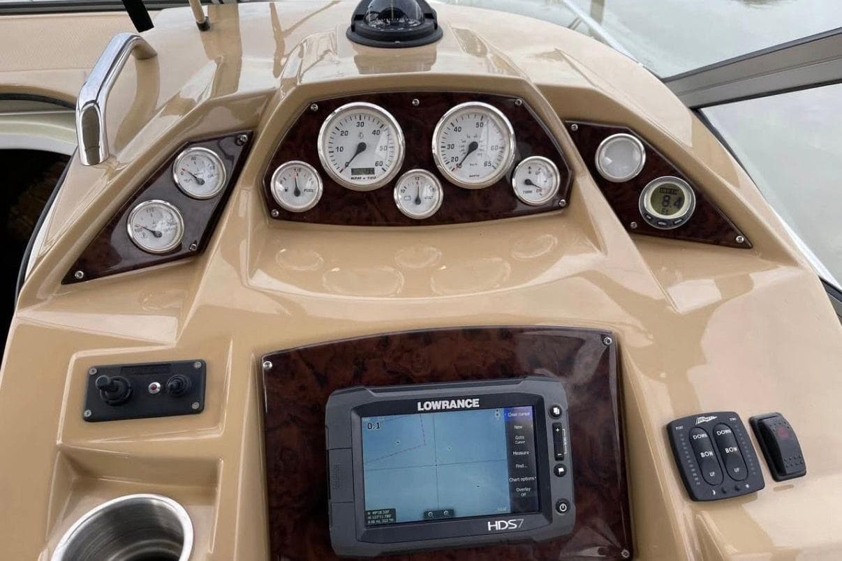 Dashboard of a 2014 Larson Cabrio 285 boat with gauges and navigation system.