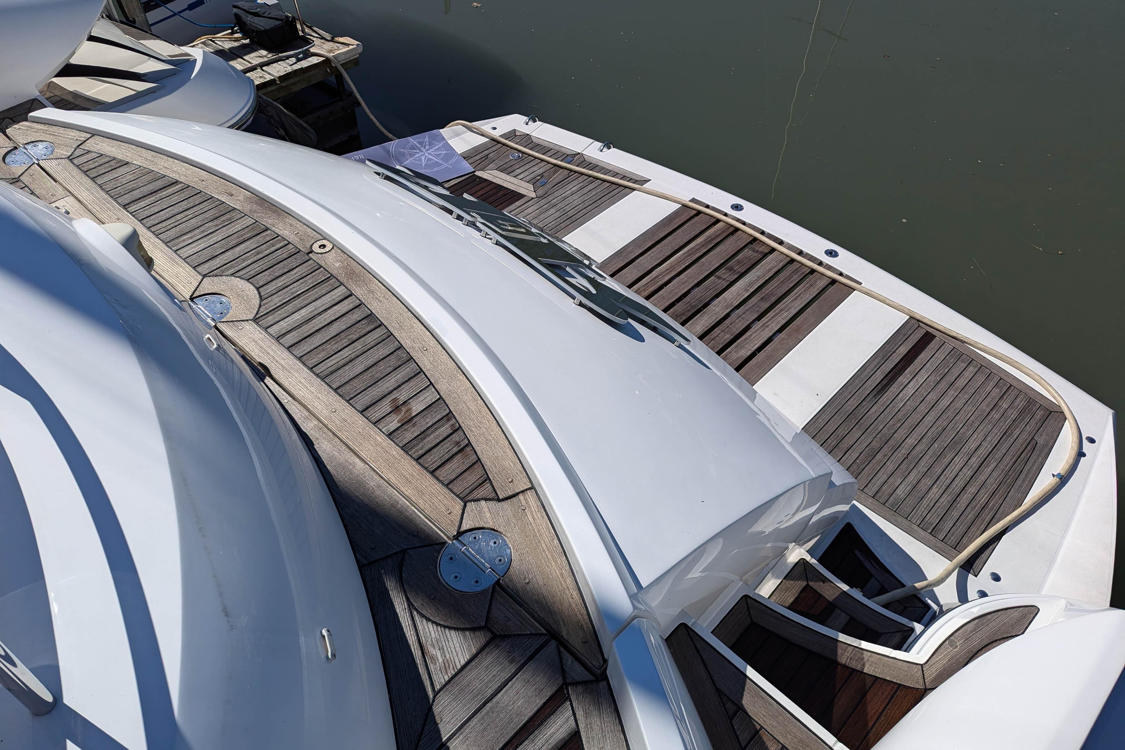Sunseeker Predator 68 yacht, 2006 model, featuring elegant wooden deck design.