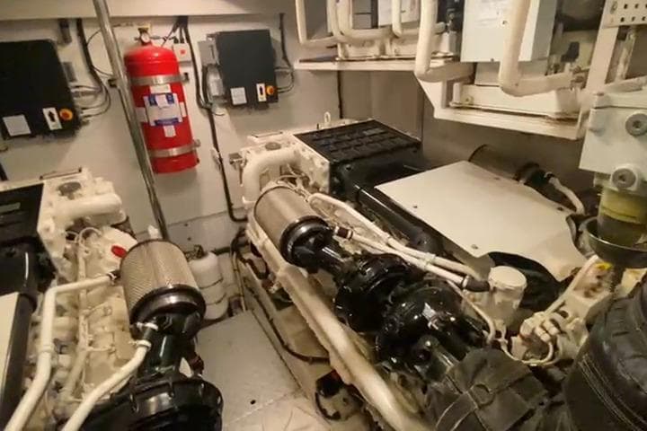 Engine room of a 2007 Princess 21M yacht, featuring machinery and fire safety equipment.