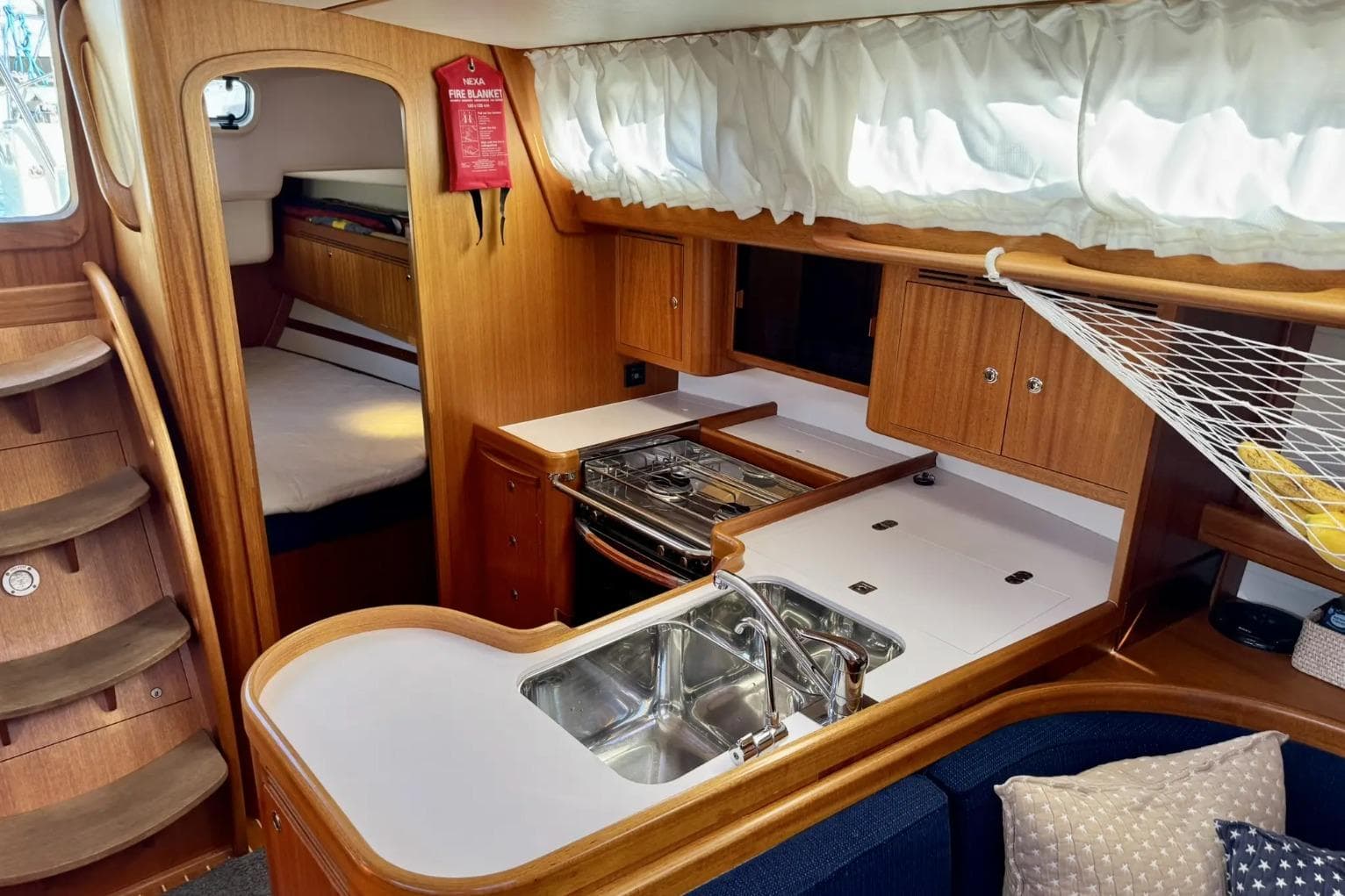 Interior of 2010 Arcona 430 yacht with kitchen, sink, and cozy cabin area.