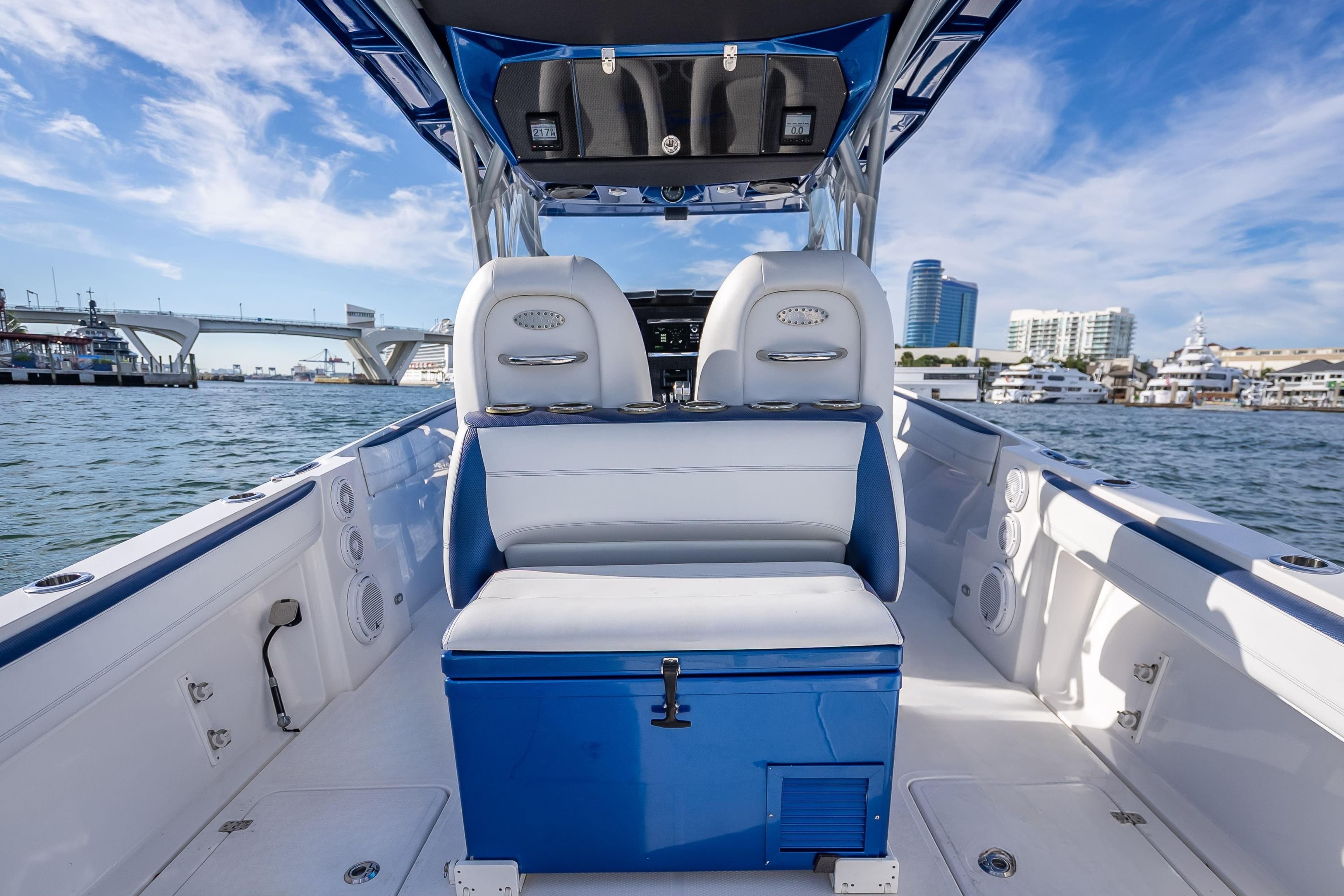 2015 Nor-Tech 340 Sport Center Console boat interior with blue and white seating, dockside view.