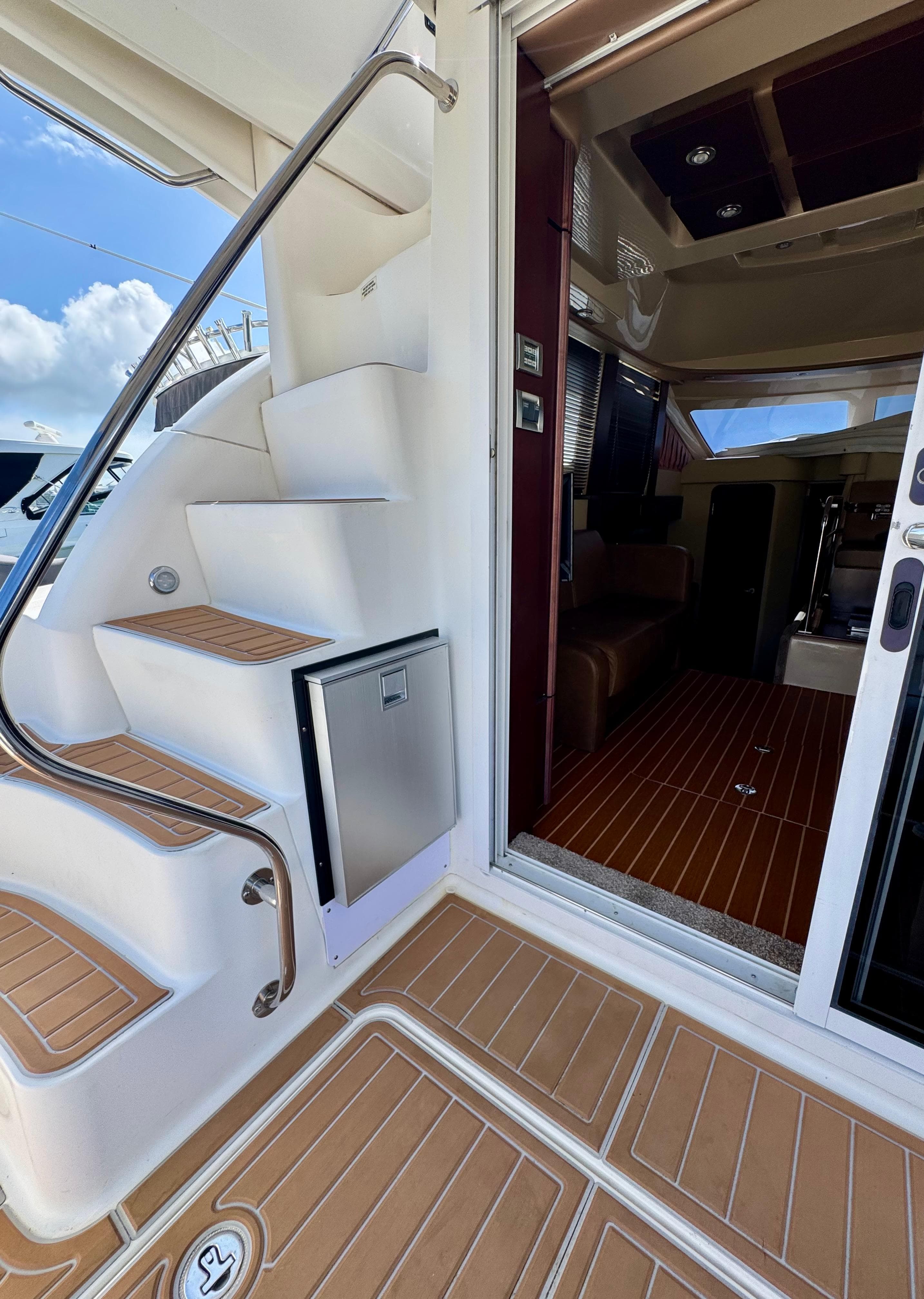 2007 Sea Ray 360 Sedan Bridge yacht interior with stairs and wooden flooring.