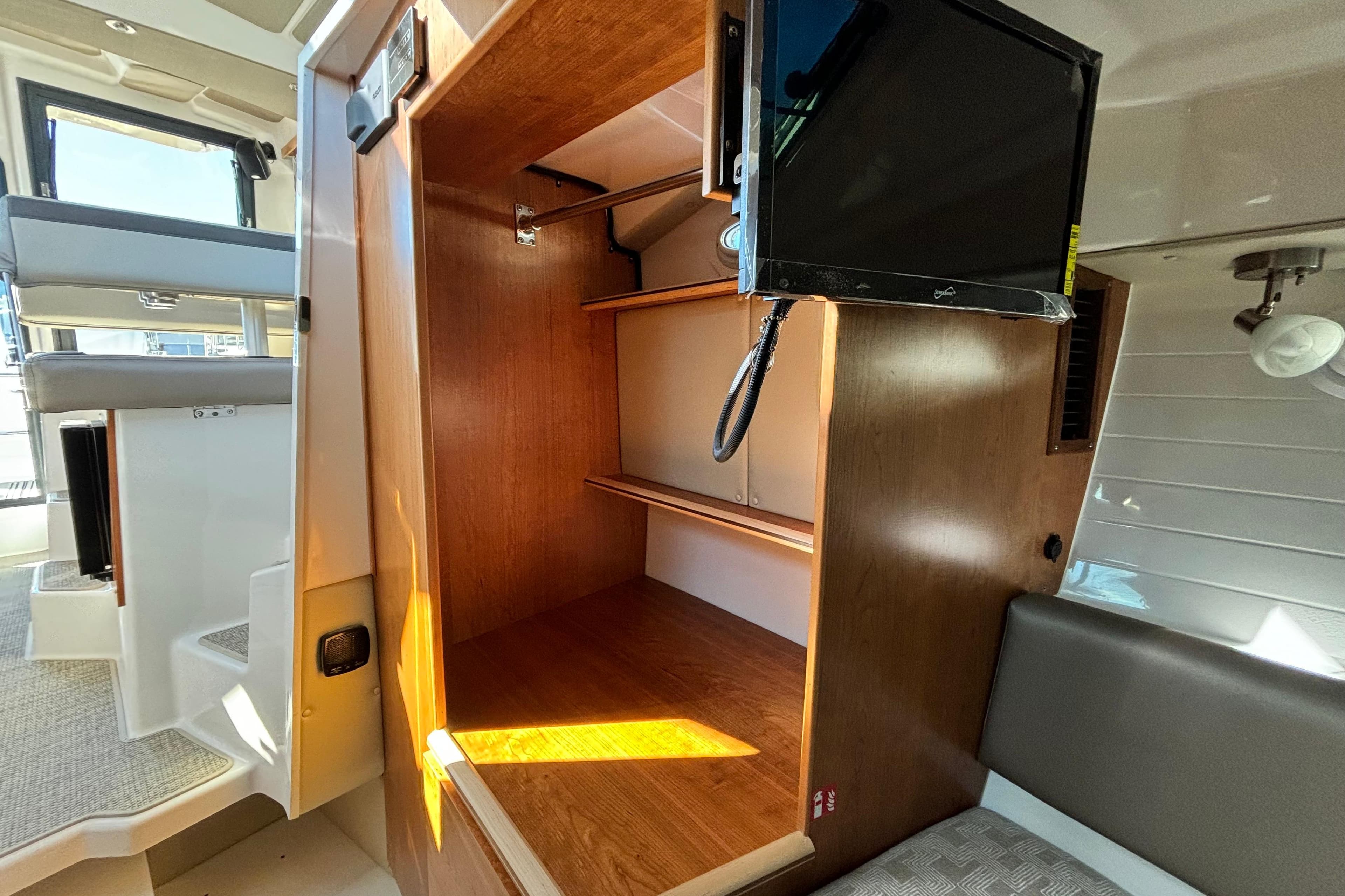 Interior of 2026 Cutwater C-288 Coupe with storage and TV.