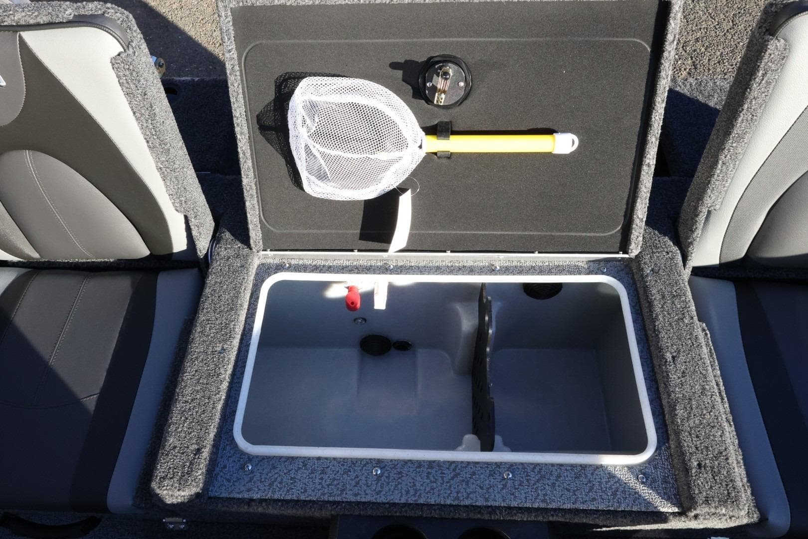 2026 Lund 1775 Impact XS Sport boat storage compartment with net and accessories.
