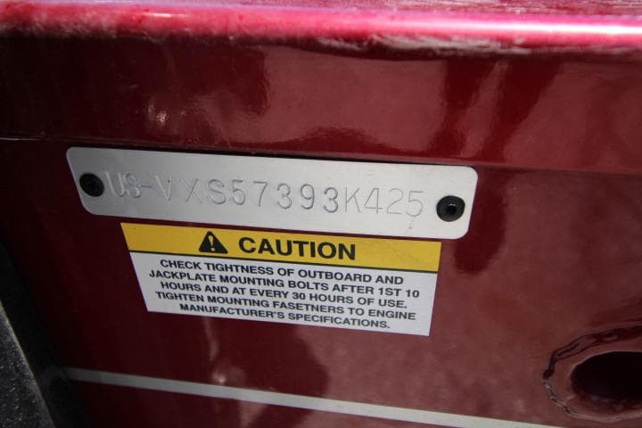 2025 Vexus ADX180LS caution label with serial number on red surface.