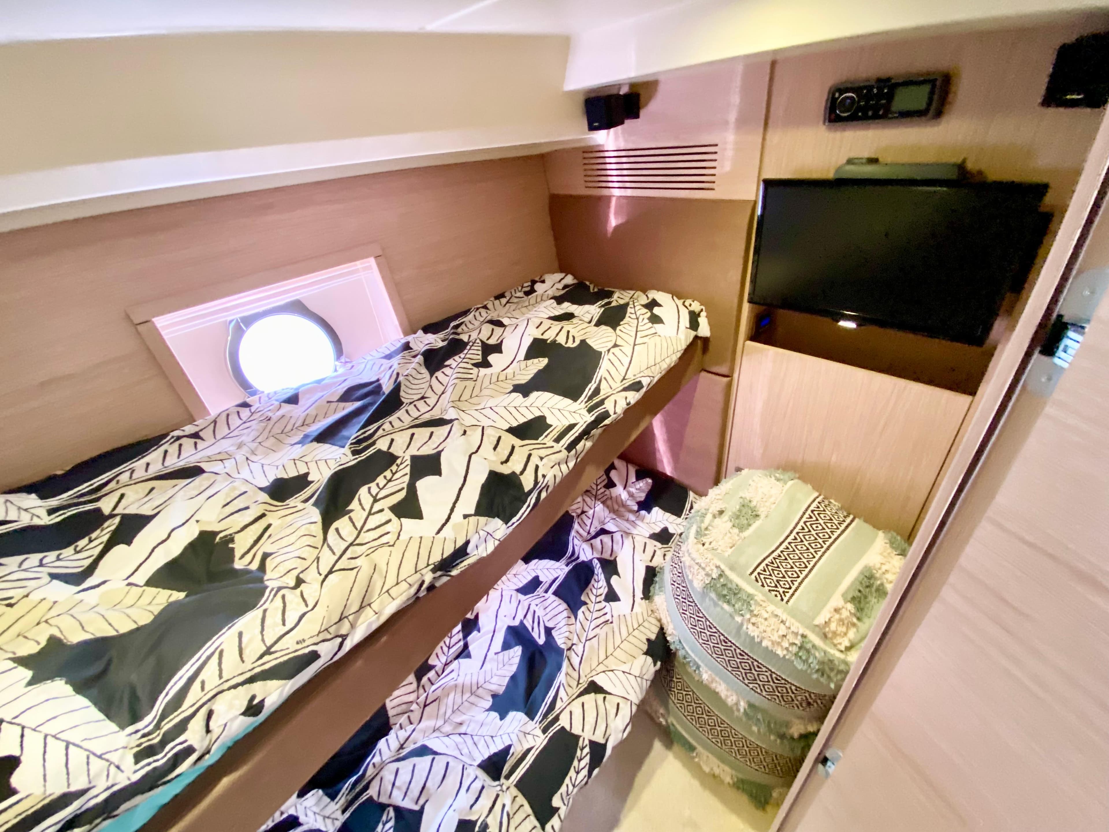 Cozy cabin interior of 2015 Monte Carlo MC5S with bunk beds and porthole window.
