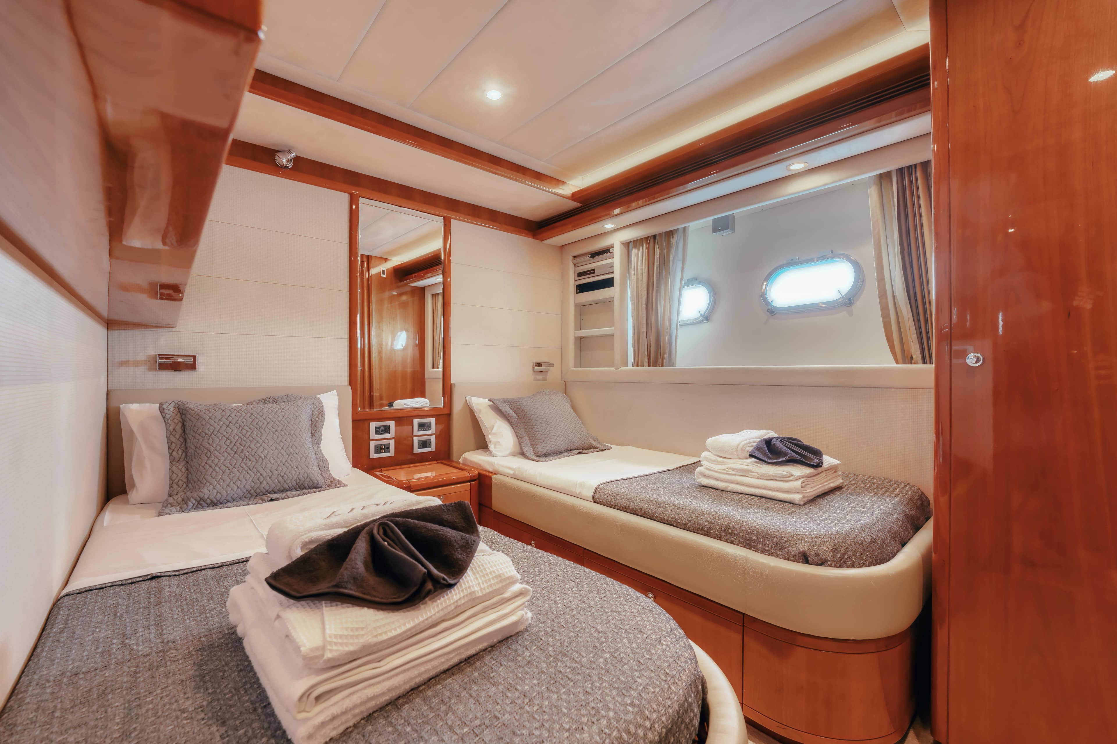 Luxurious twin cabin interior of 2006 Ferretti Yachts 830 with elegant bedding.