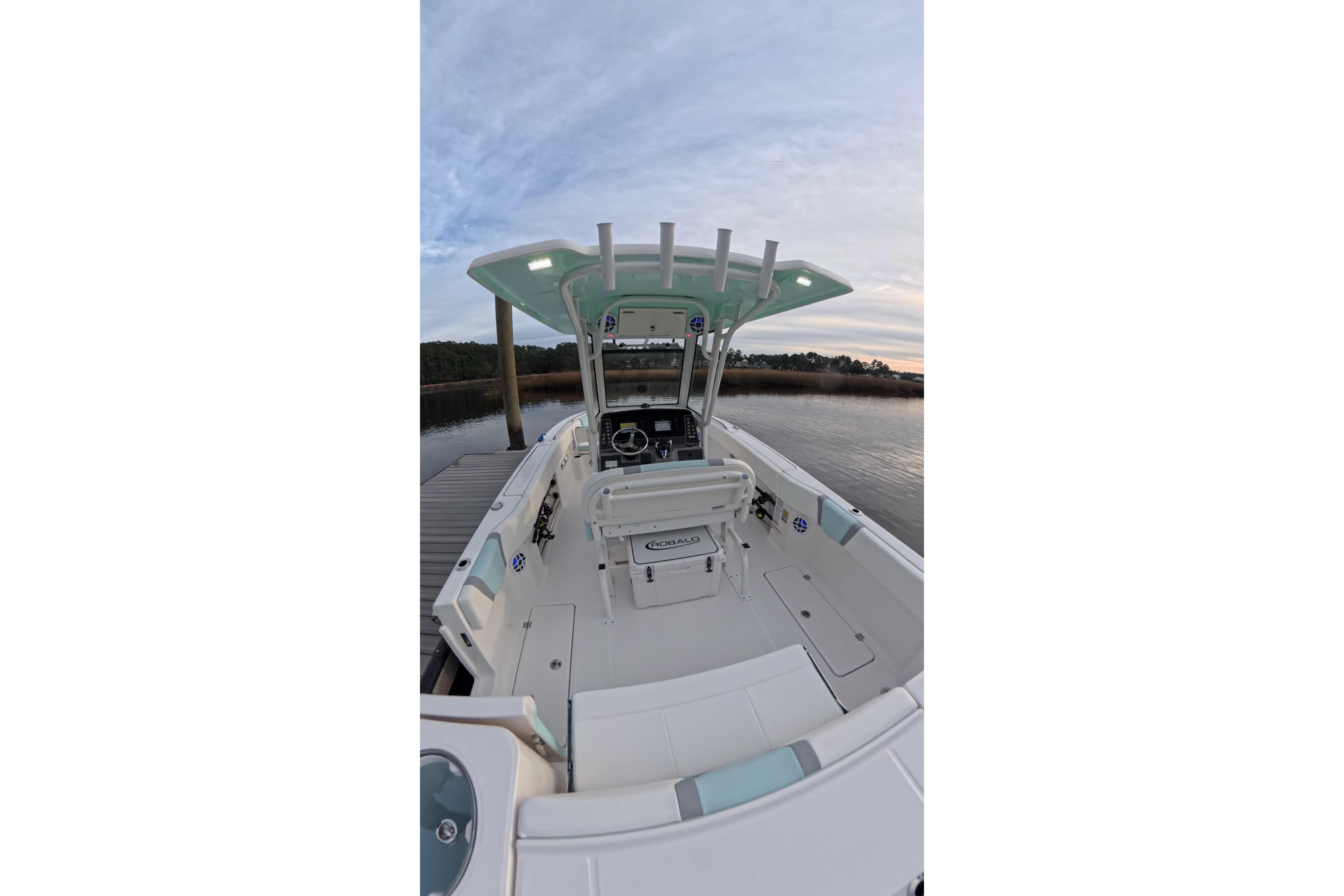 2025 Robalo R250 Center Console boat docked by serene waters.