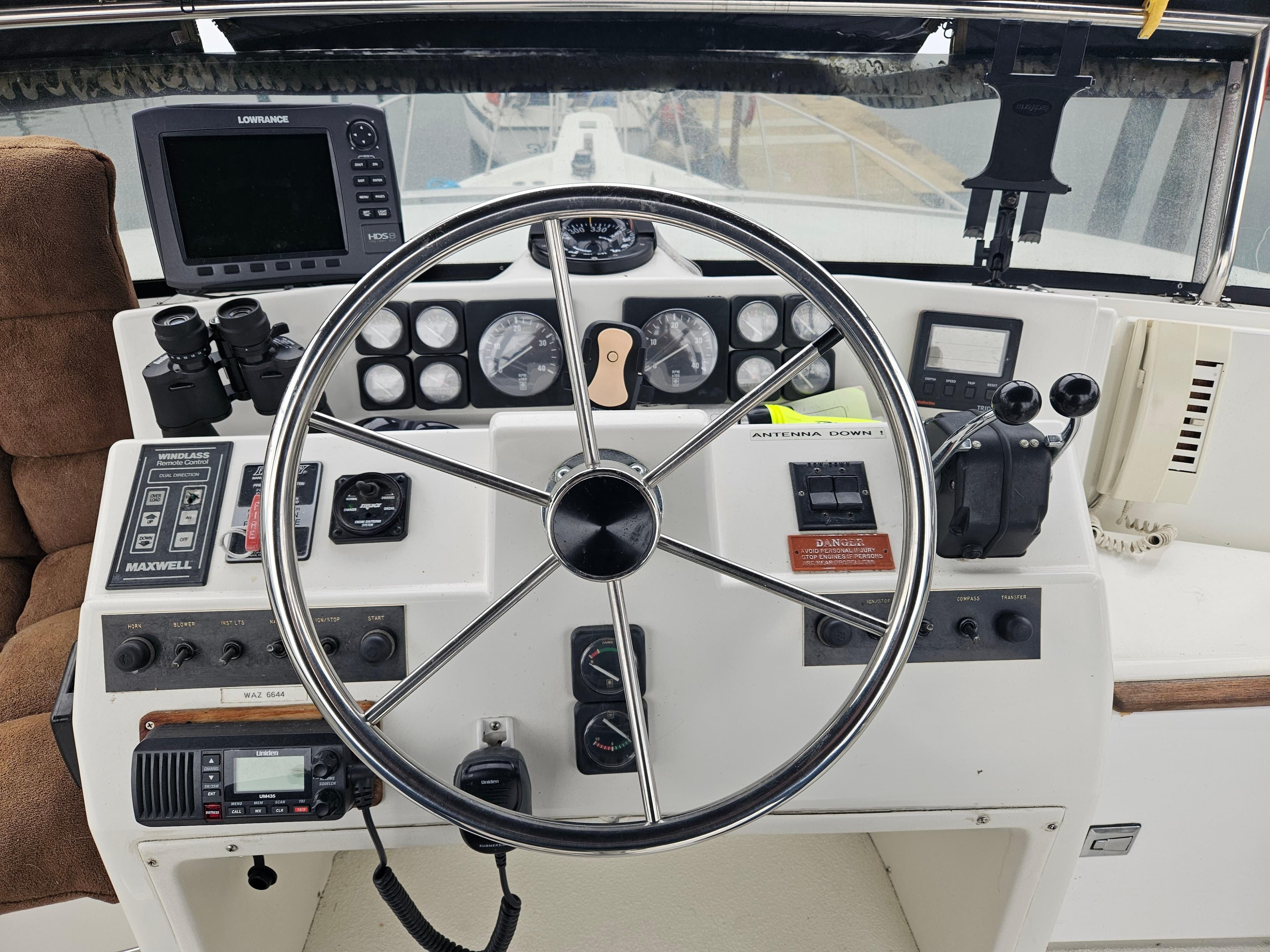 1991 Tollycraft Euro Sport Sedan helm with steering wheel, gauges, and navigation equipment.