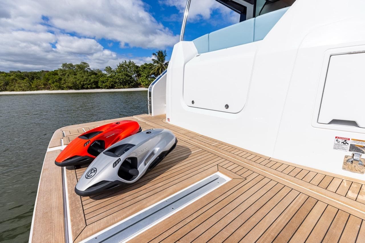 2026 Cruisers Yachts 50 Fly deck with two sleek water scooters.