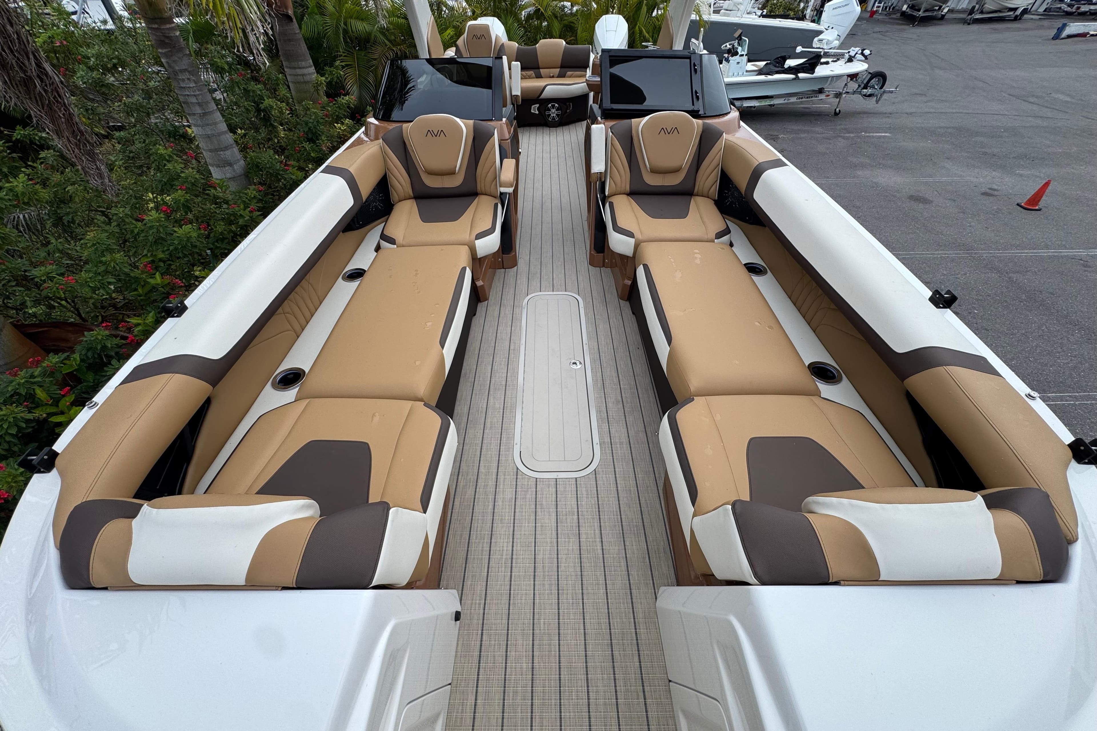 Luxurious interior of 2026 Avalon Excalibur 27' boat with tan and brown seating.