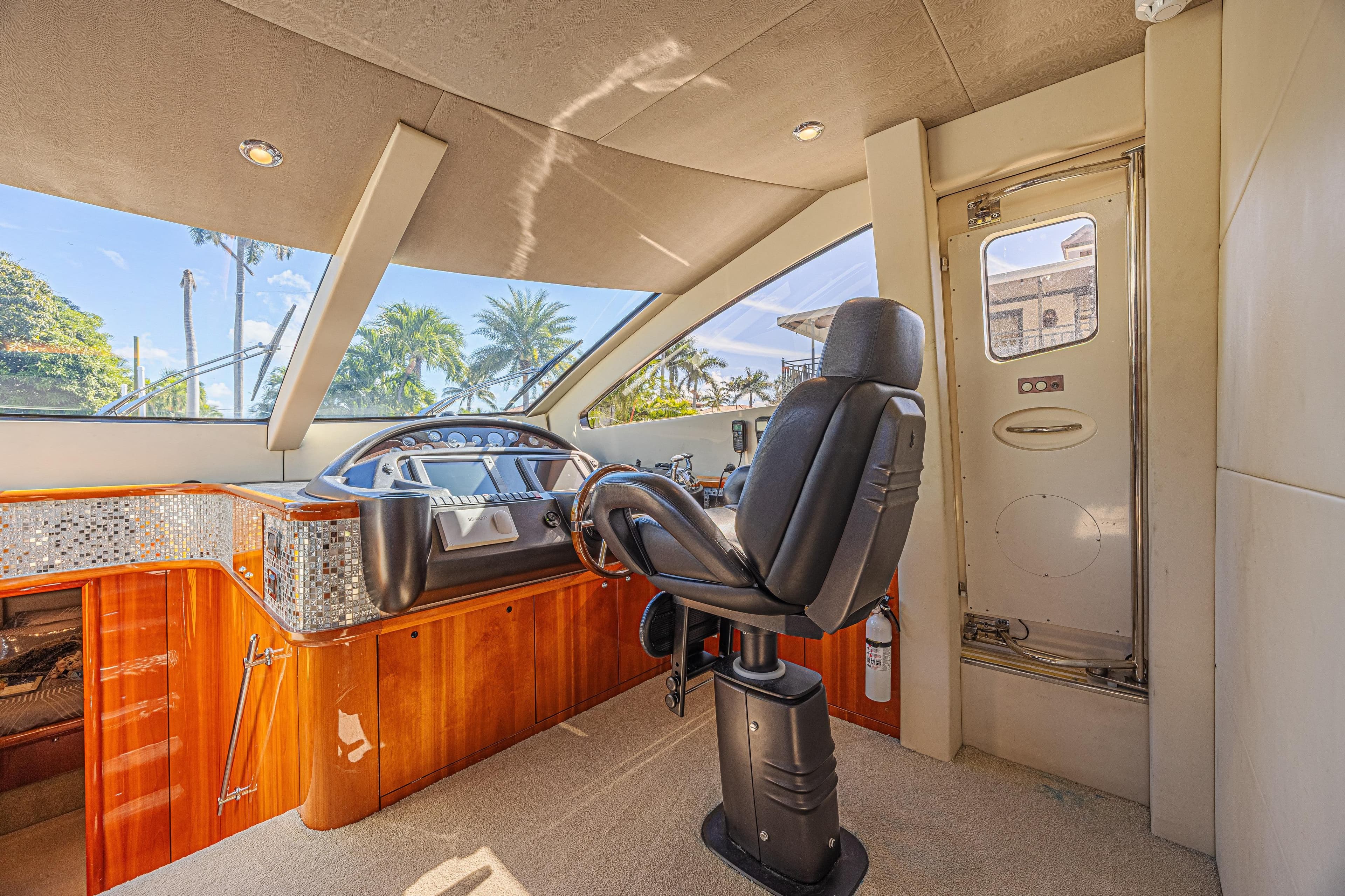 Luxurious helm of 2006 Sunseeker 75 Yacht with modern controls and panoramic windows.