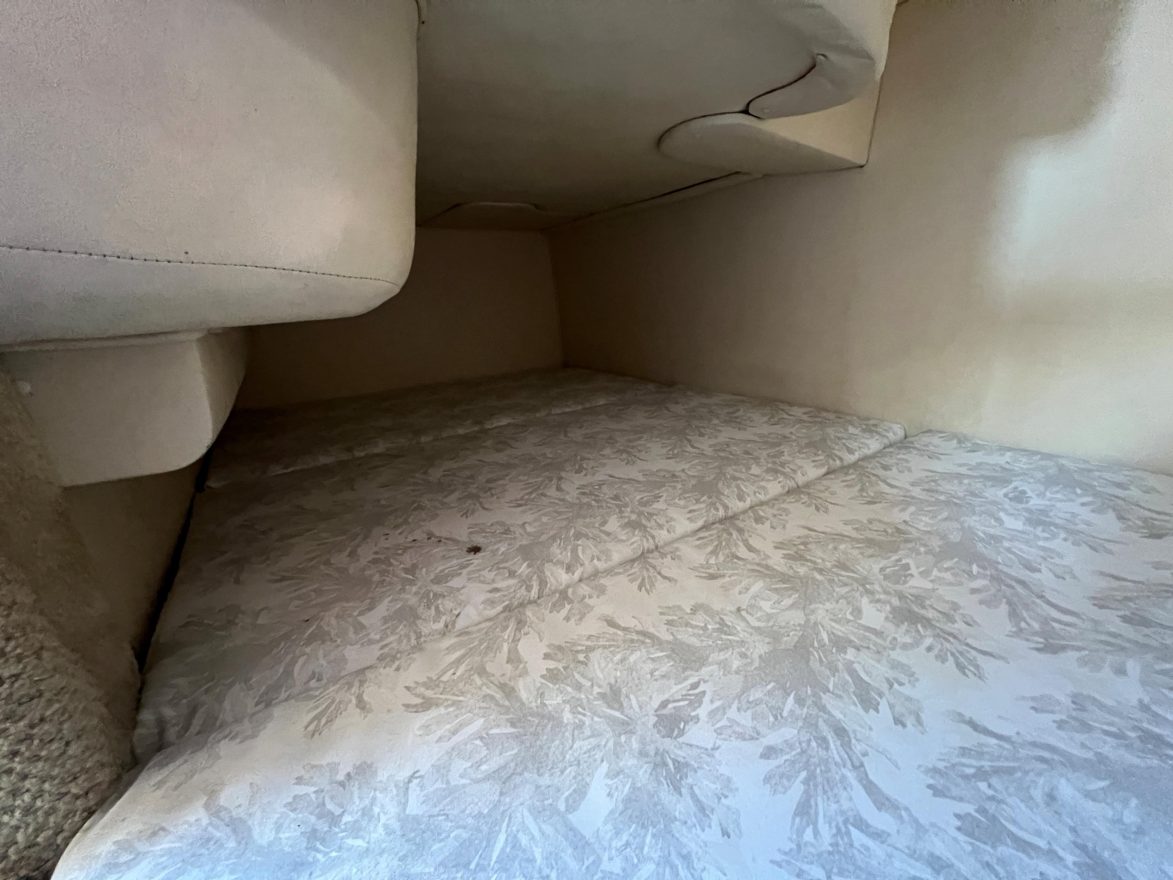 Interior cabin of 2005 Sea Ray 280 Sundancer with patterned upholstery.