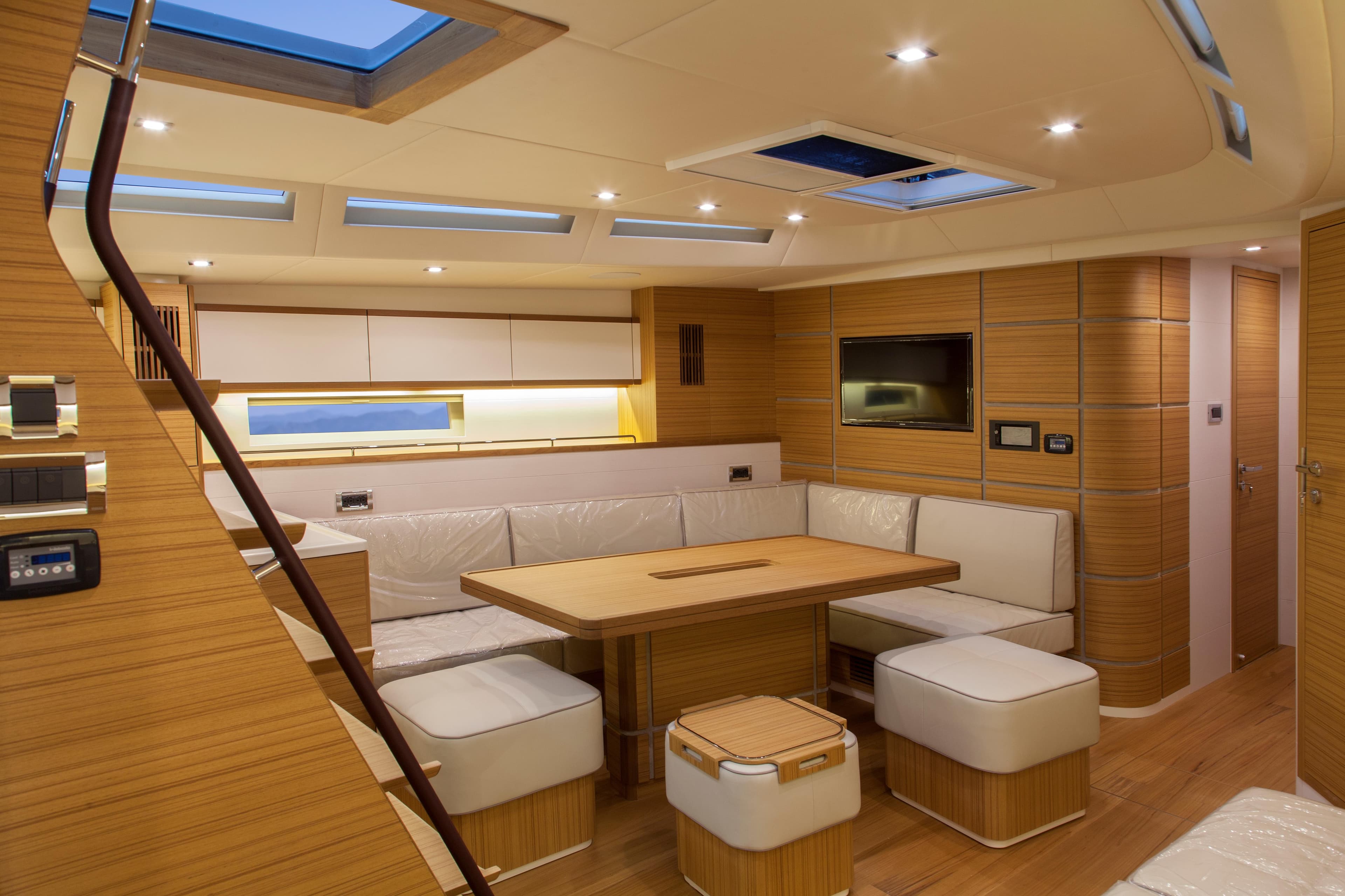 Luxurious interior of 2026 Mazarin 72 Cruiser/Racer yacht with modern seating and lighting.