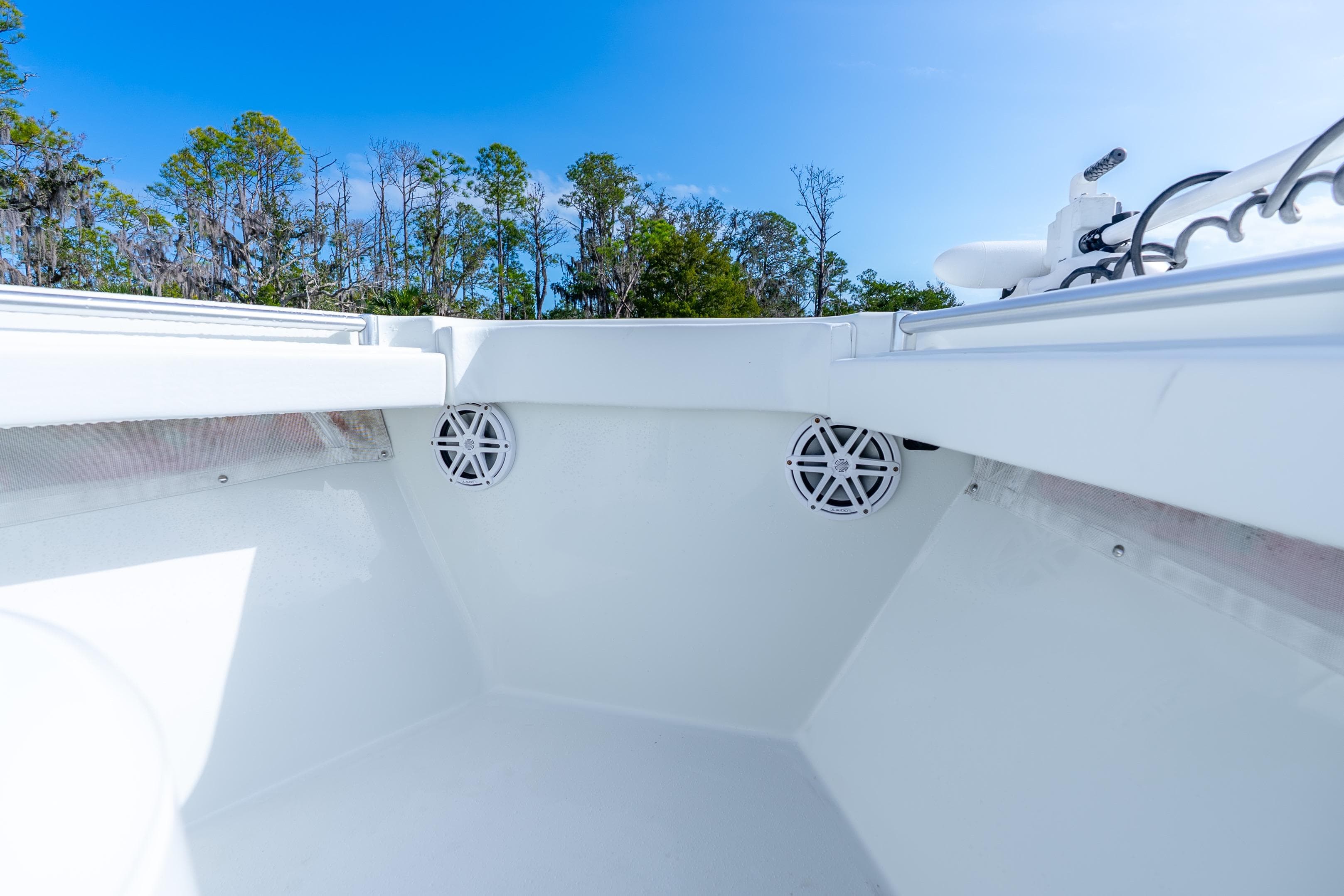2014 Yellowfin 32 Offshore boat interior with speakers, under clear blue sky.