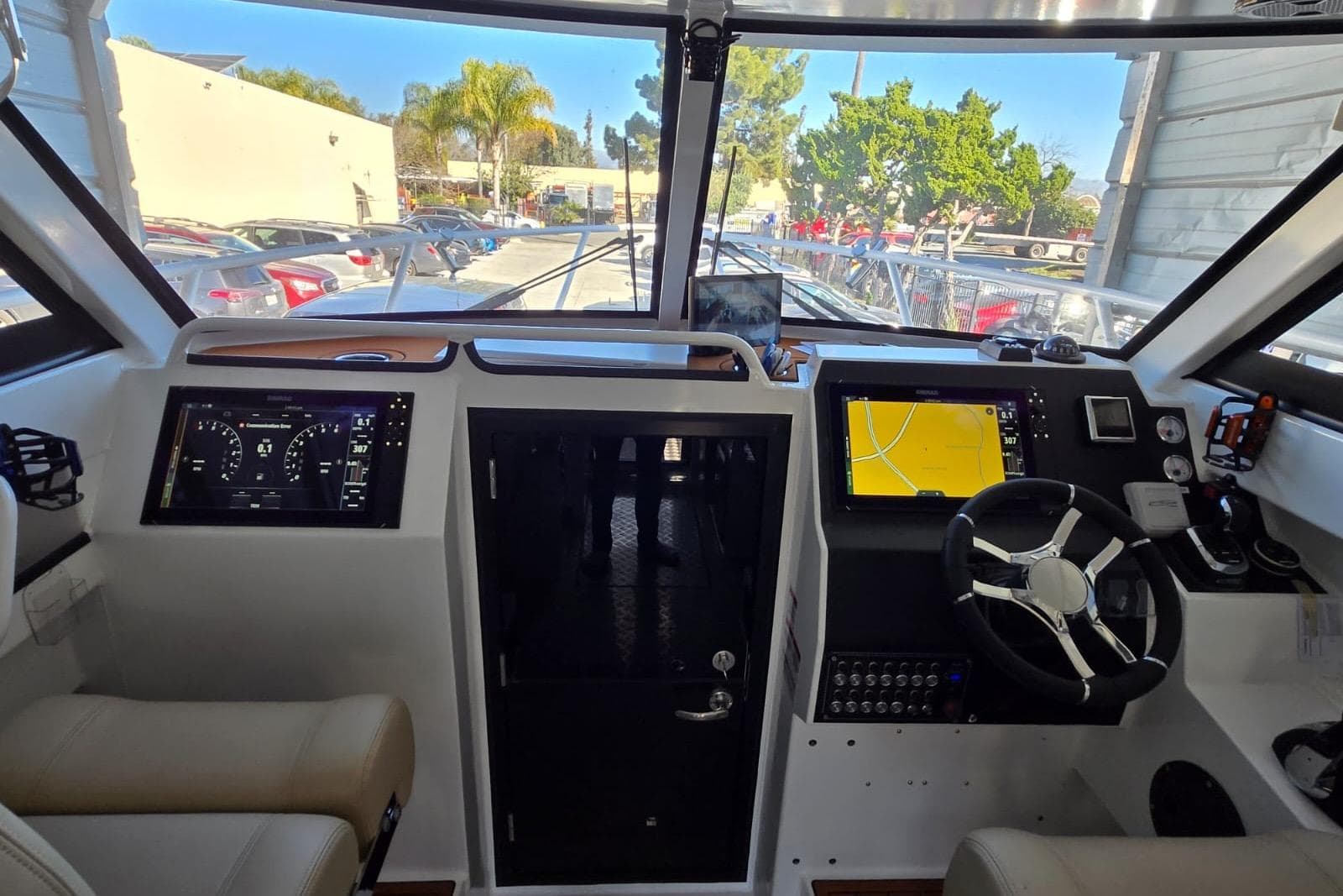 Interior cockpit of 2025 Custom Boat 34 with modern navigation displays.