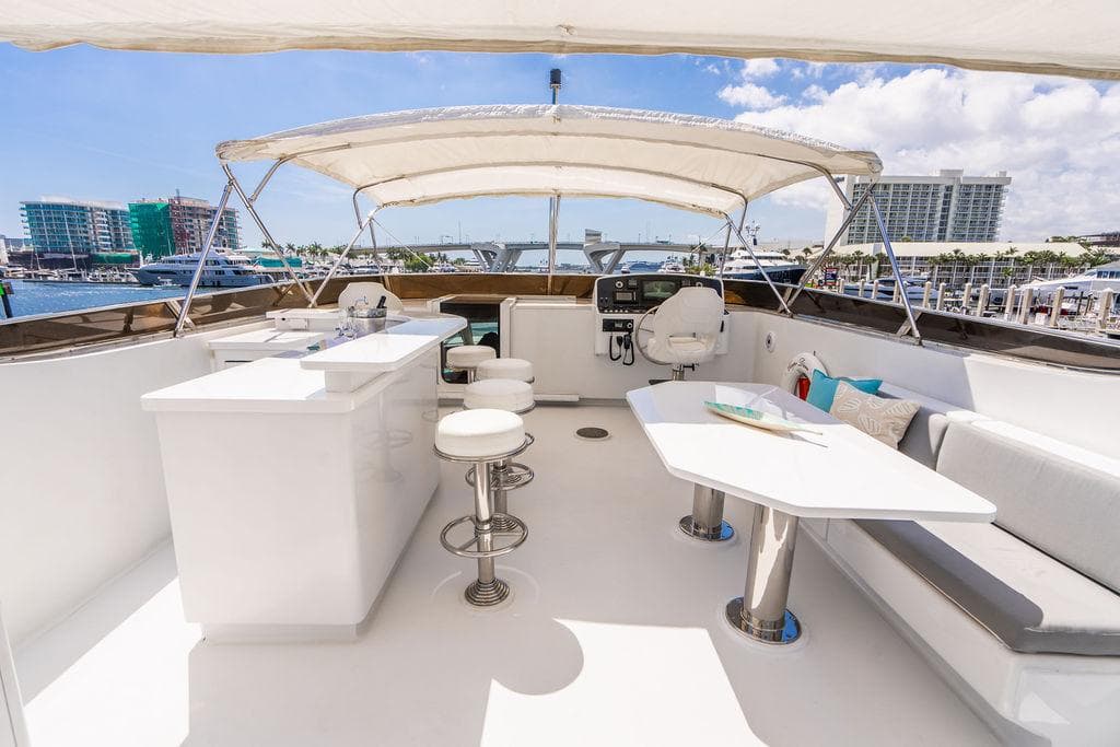 2001 Intermarine Raised Pilothouse yacht with spacious flybridge and modern seating area.