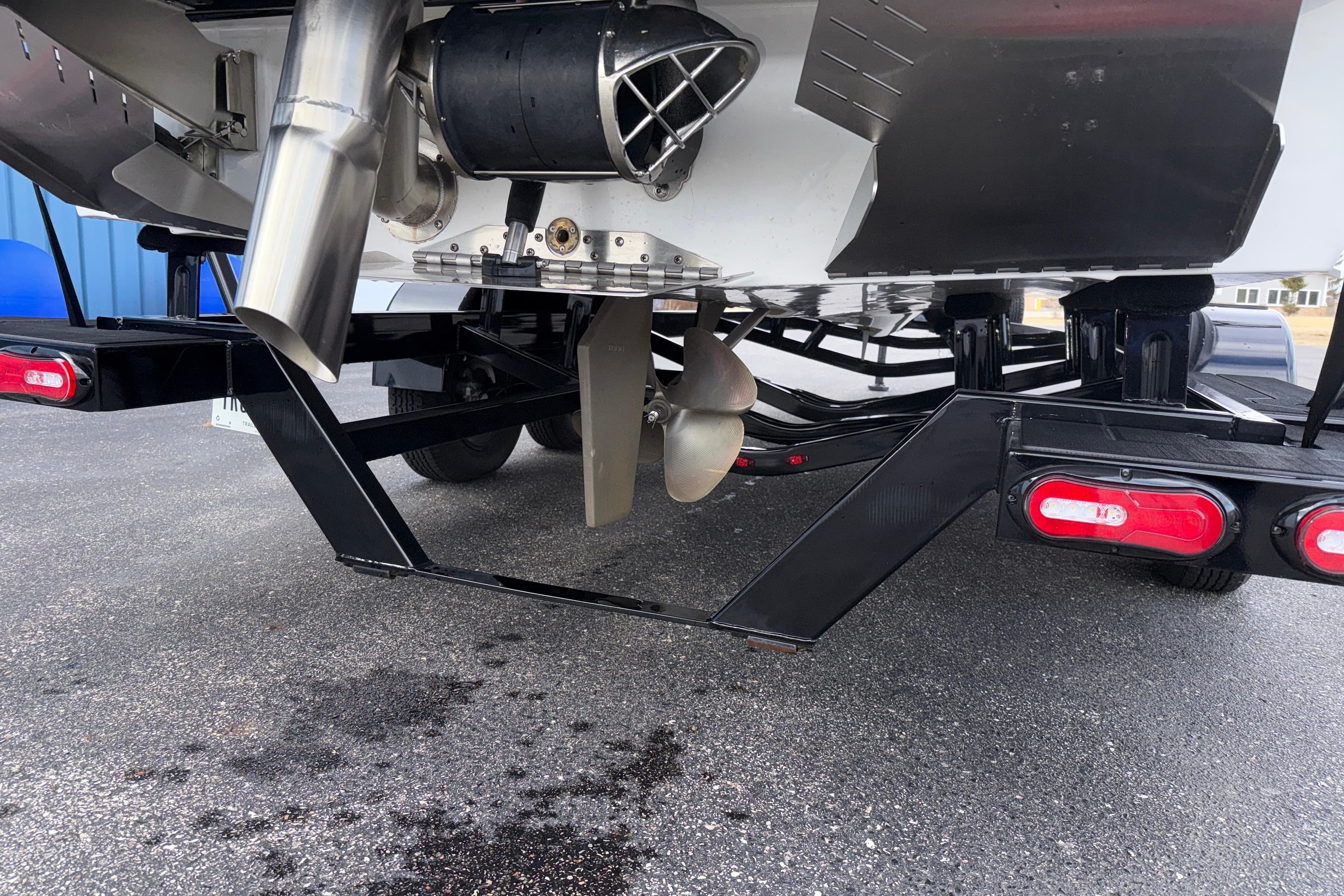 2023 Tigé 23ZX boat trailer with propeller and exhaust system.