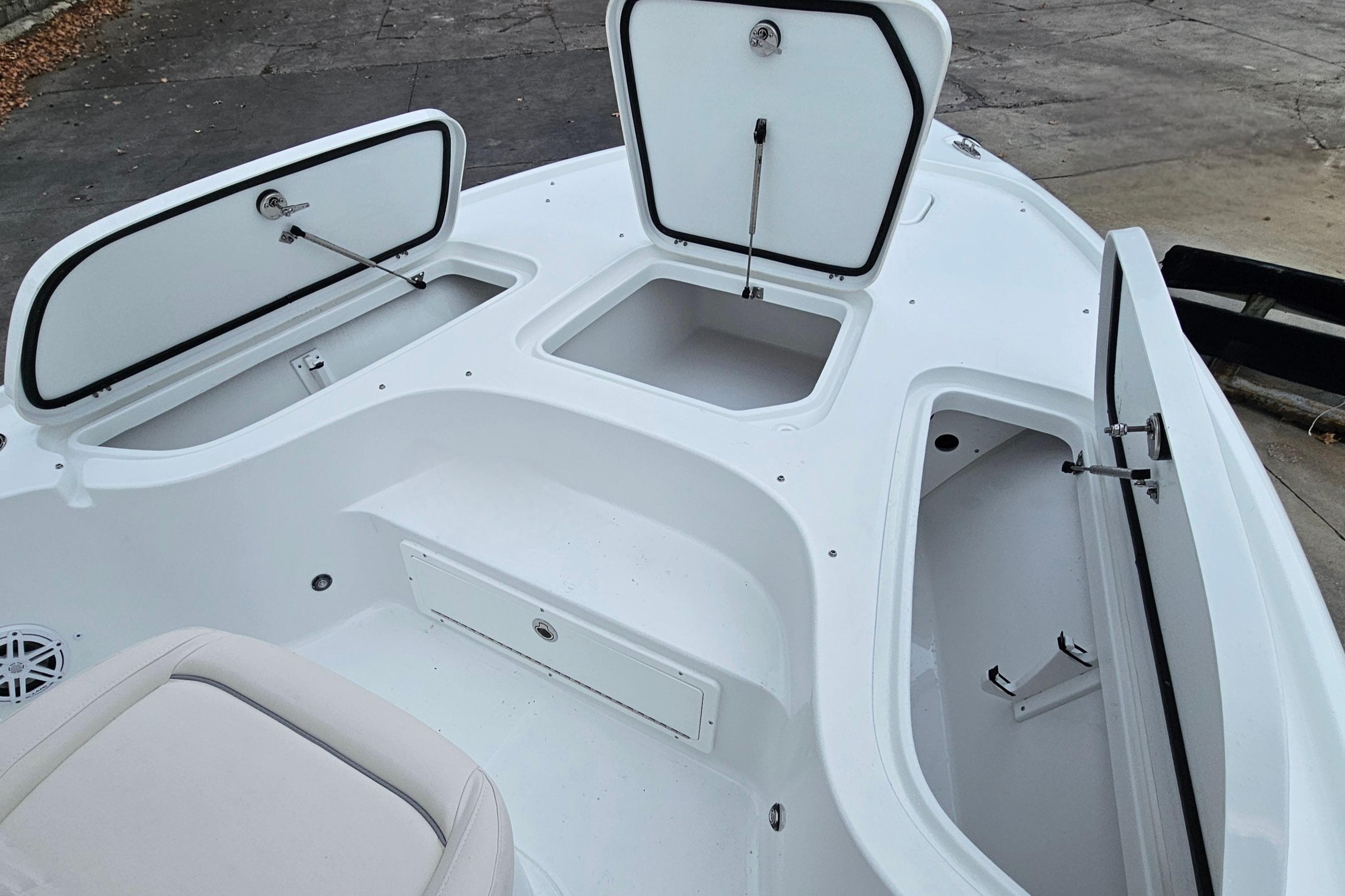 2026 Sea Hunt BX 22 BR boat storage compartments open, showcasing spacious interior design.