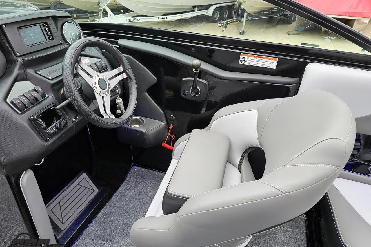 2018 Supreme S226 boat interior with steering wheel, dashboard, and comfortable seating.