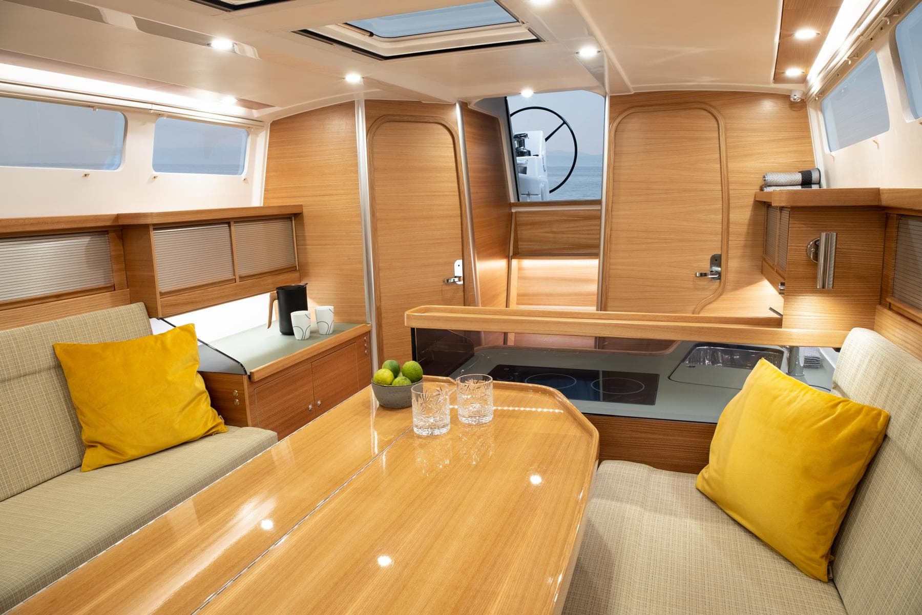 Luxurious interior of 2025 Dragonfly 40 yacht with modern wood finish and cozy seating.