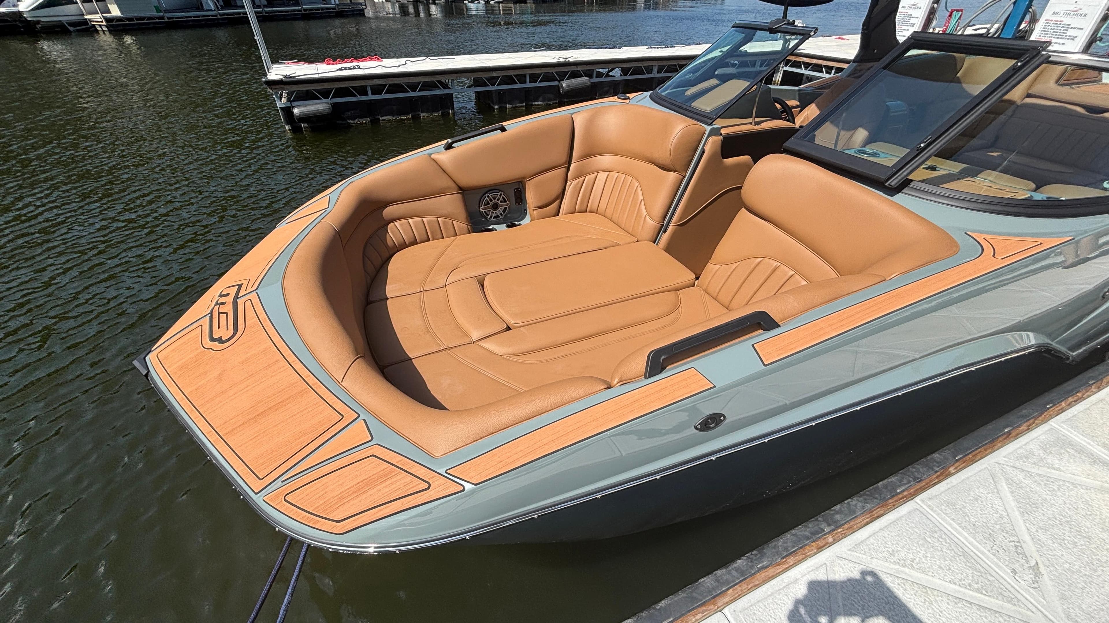 Luxury MB B52 25 Alpha boat, 2025 model, with tan leather seating, docked on water.