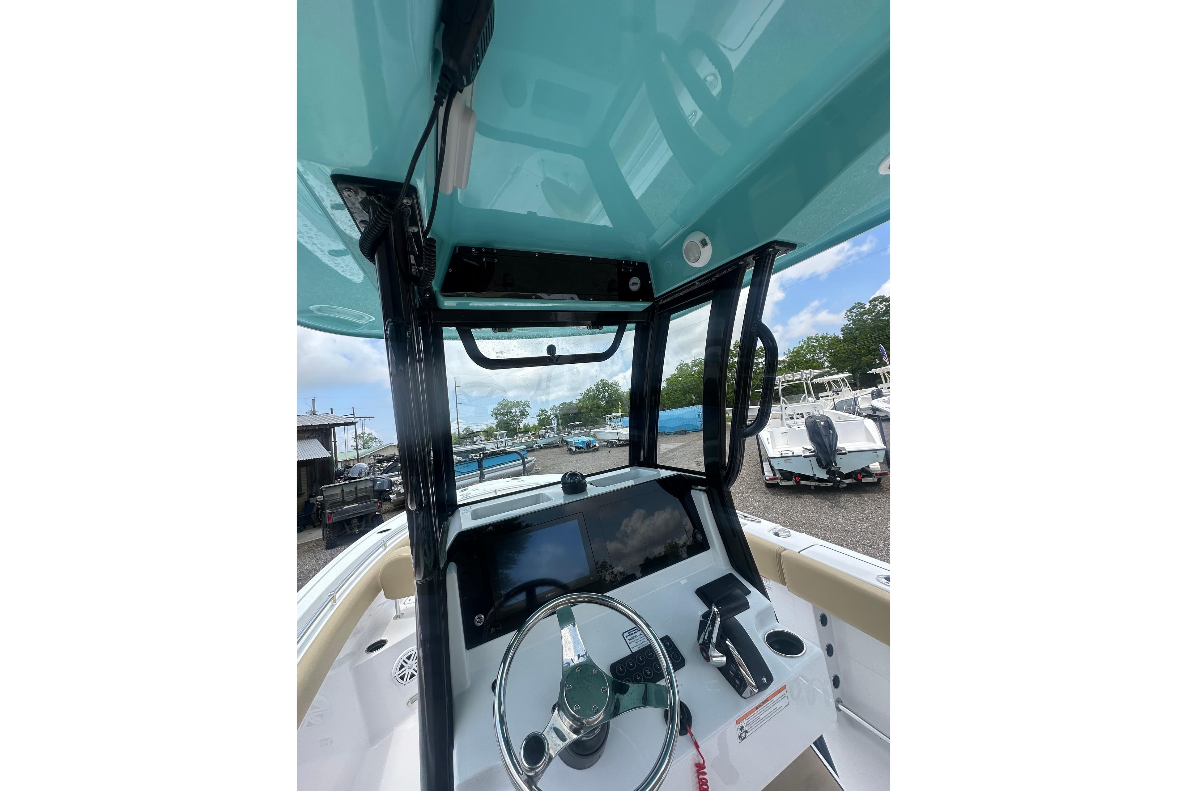 2026 Sportsman Open 232 Center Console boat interior with steering wheel and control panel.