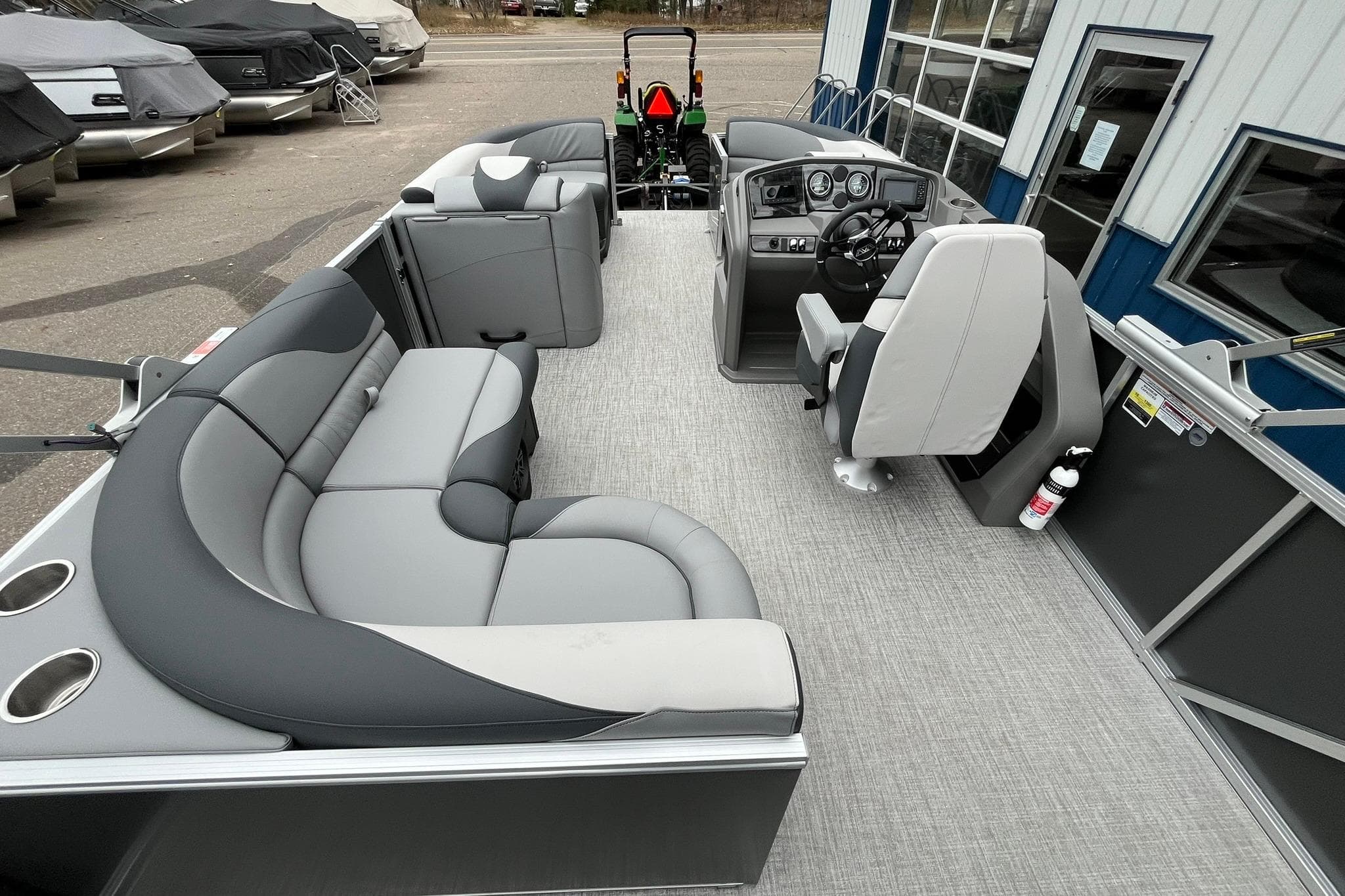 2025 Avalon LSZ Rear Fish pontoon boat interior with gray seating and modern dashboard.