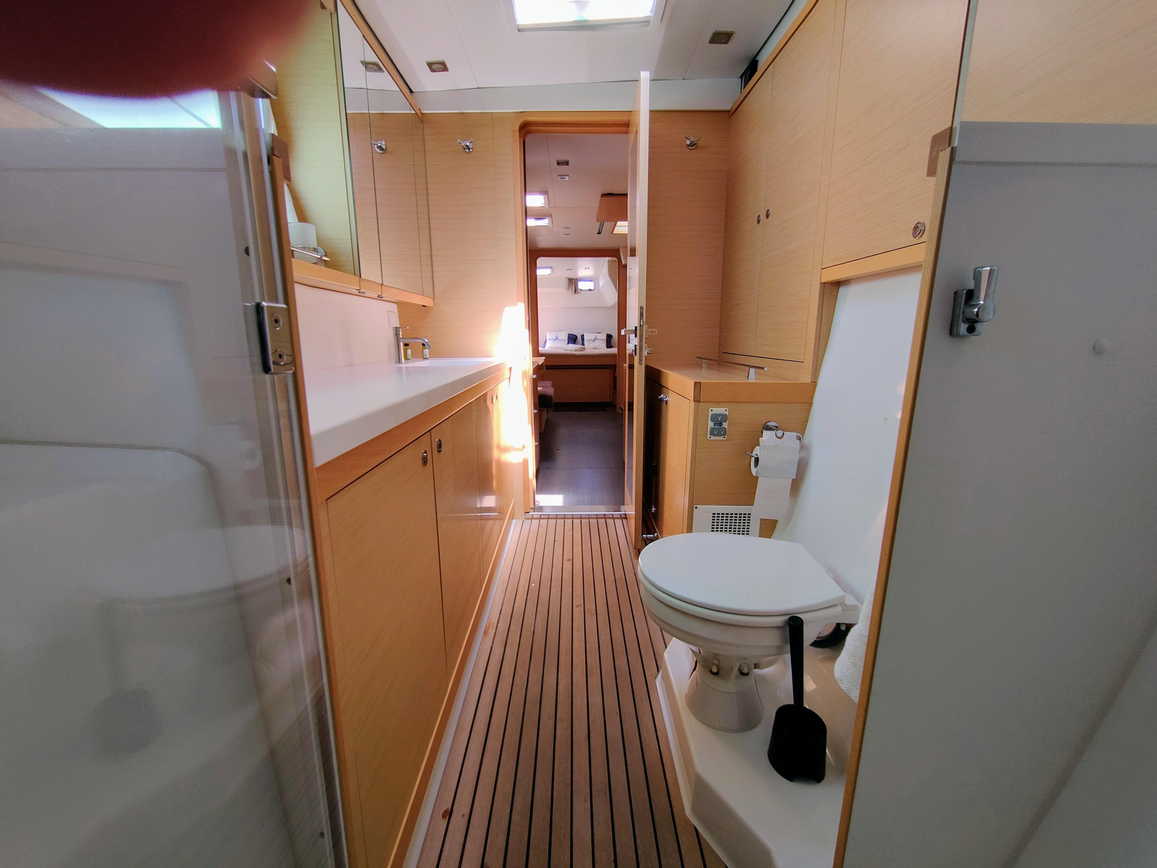 Interior of 2013 Lagoon 450 F yacht bathroom with wooden flooring and modern fixtures.