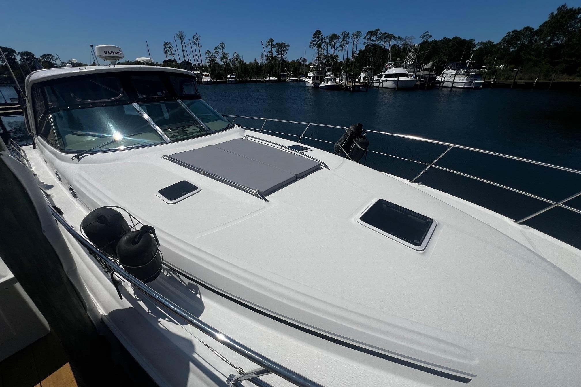 2003 Sea Ray 410 Express Cruiser docked at marina, sunny day, calm waters.