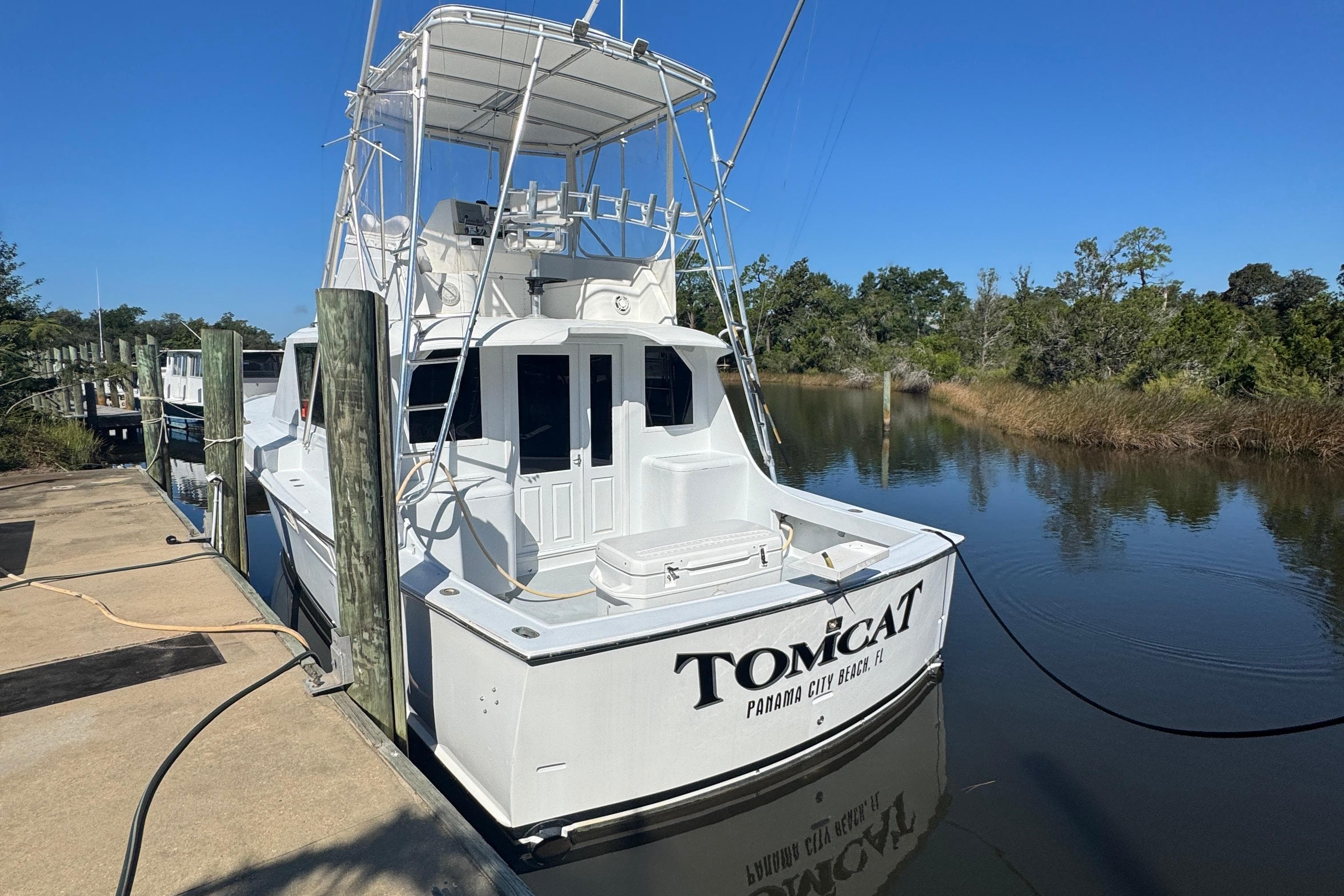 1965 Hatteras 41 Convertible boat docked in a serene marina setting.