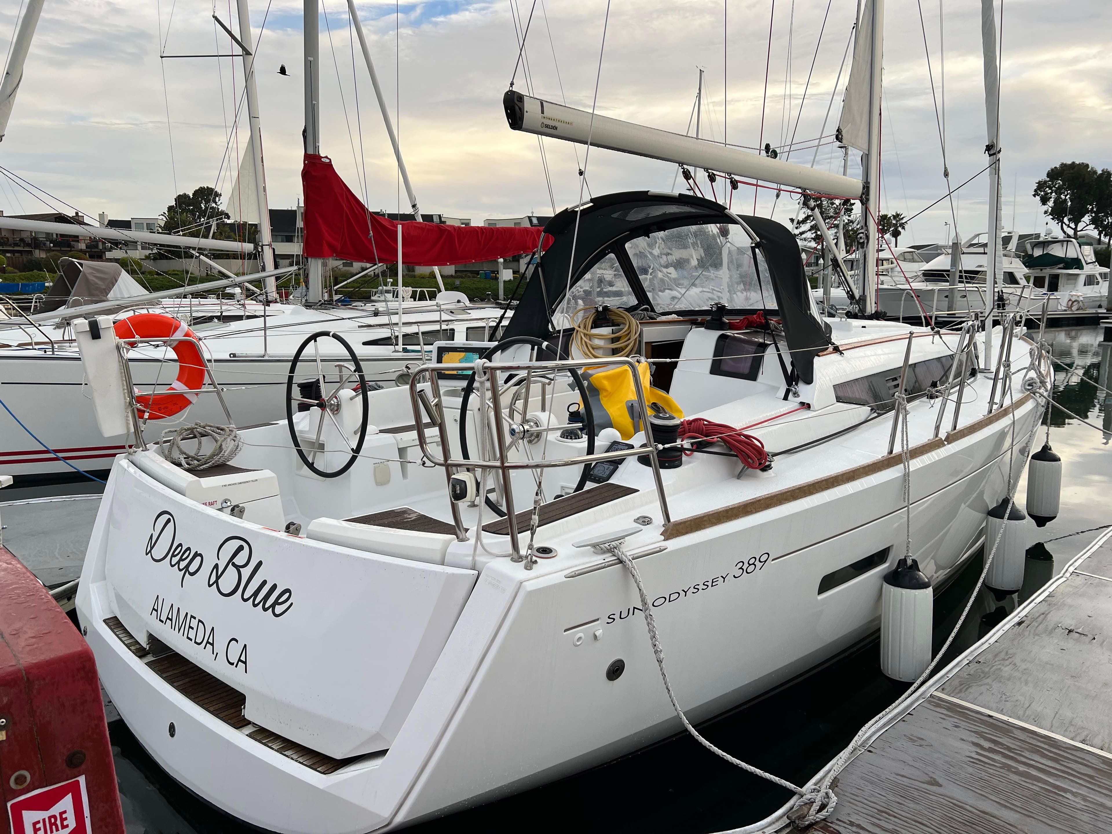 2020 Jeanneau Sun Odyssey 389 sailboat docked, named "Deep Blue," in Alameda, CA marina.