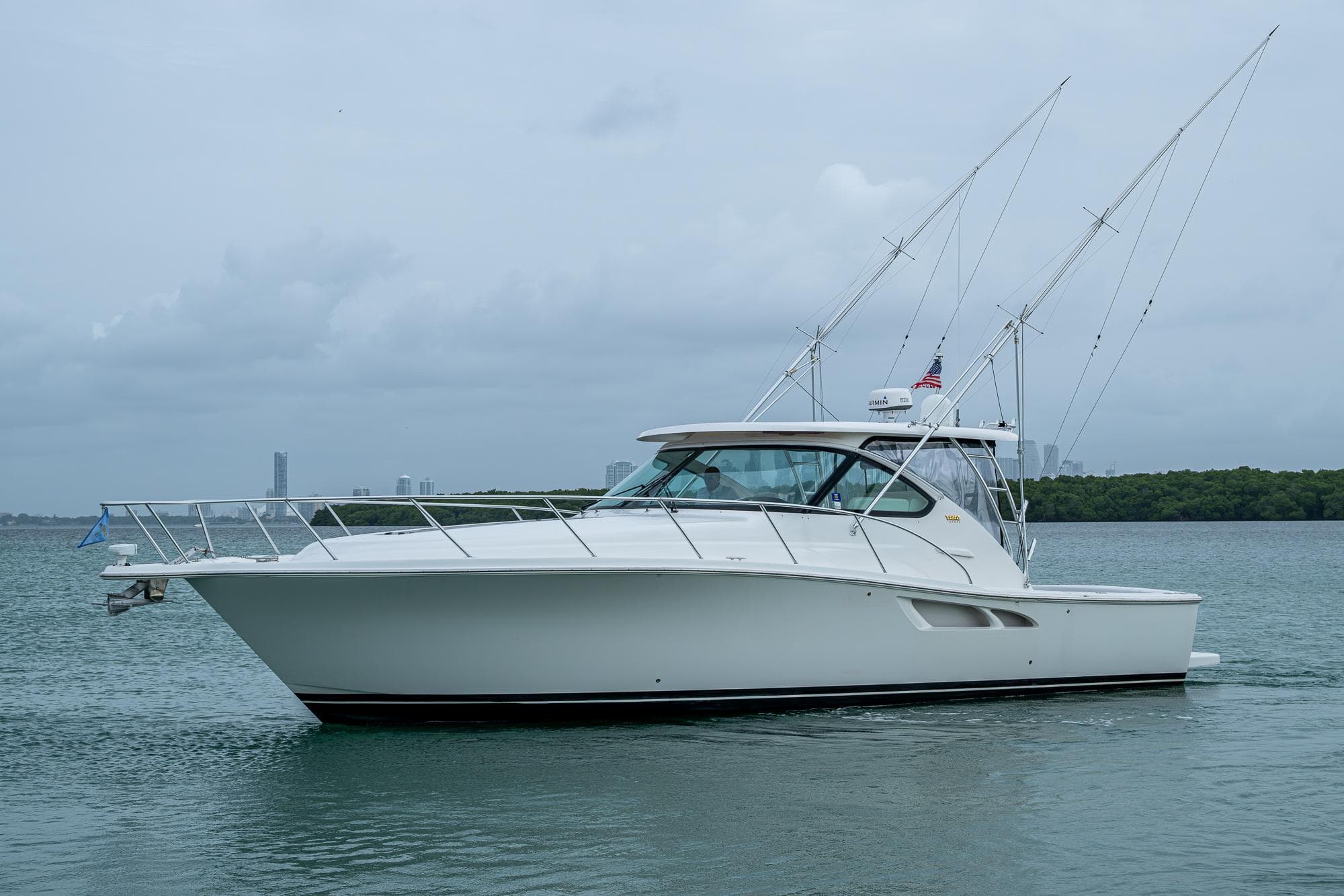 2009 Tiara Yachts 39 Open cruising on calm waters, side view.